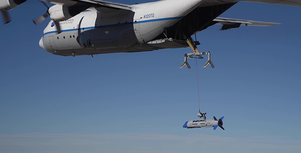 An X-61 Gremlin Air Vehicle drone and a C-130 during a flight test conducted by DARPA at Dugway Proving Ground, Utah, on Oct. 29, 2021. During the flight test, DARPA said it successfully recovered a Gremlin in midair for the first time. (DARPA)