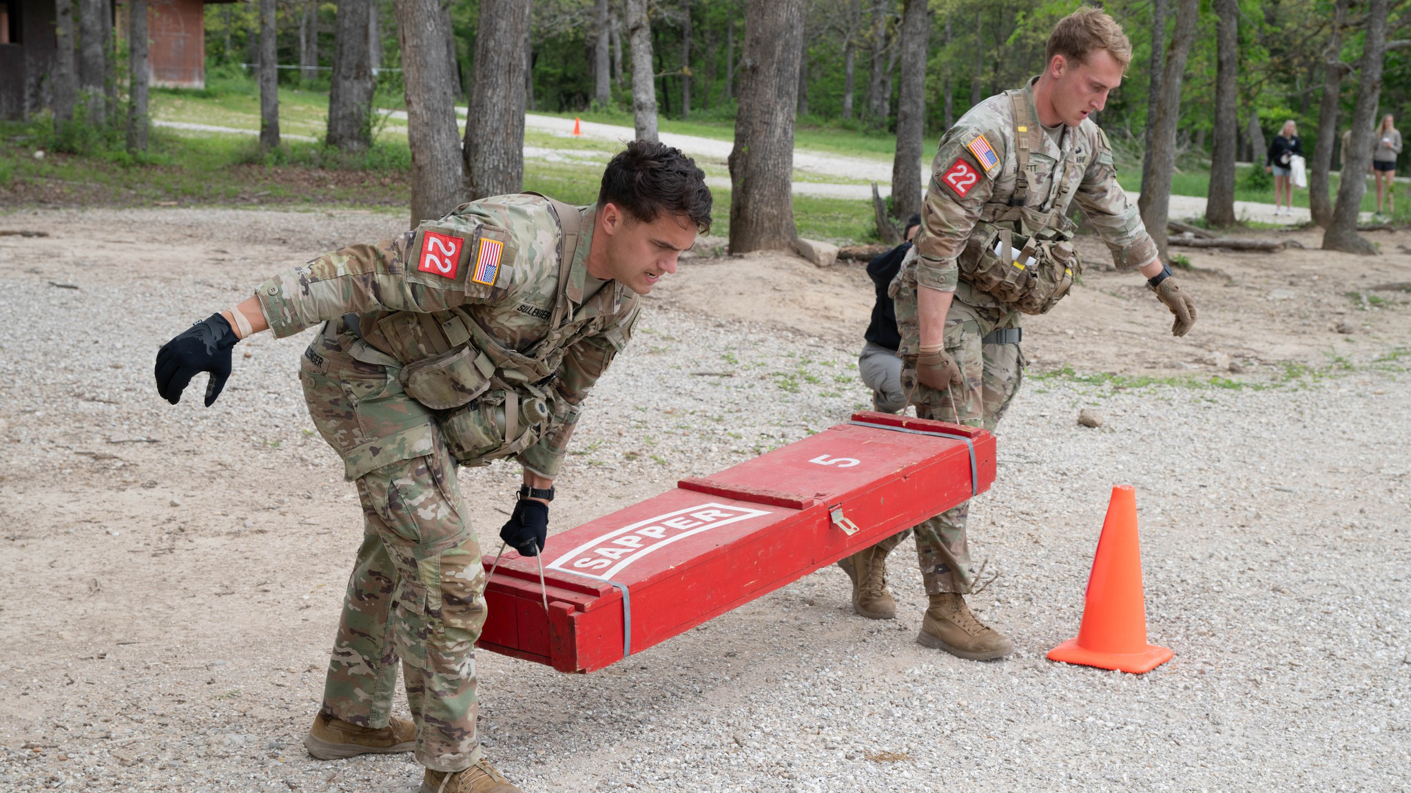 1st Lts. Christopher Barrett and Bryce Sullenger, from the 75th Ranger Regiment, carry a weight during the Best Sapper competition.