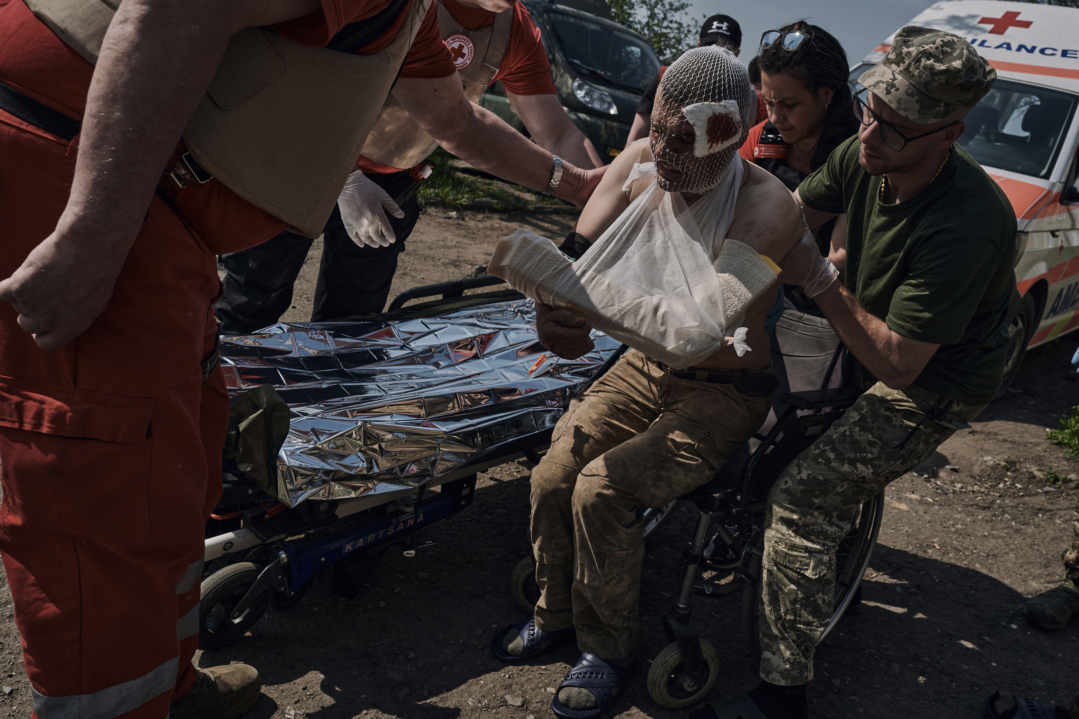 Medics help a wounded Ukrainian soldier at a medical stabilisation point near Bakhmut, Donetsk region, Ukraine, May 2023. (AP/Libkos)
