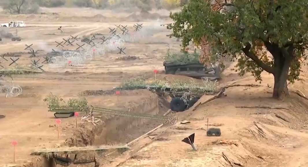 A group of engineering UGVs simulating an assault on a fortified line. A bulldozer and several bridge-laying UGVs are visible. [Source: Ministry of Defence of the Russian Federation]