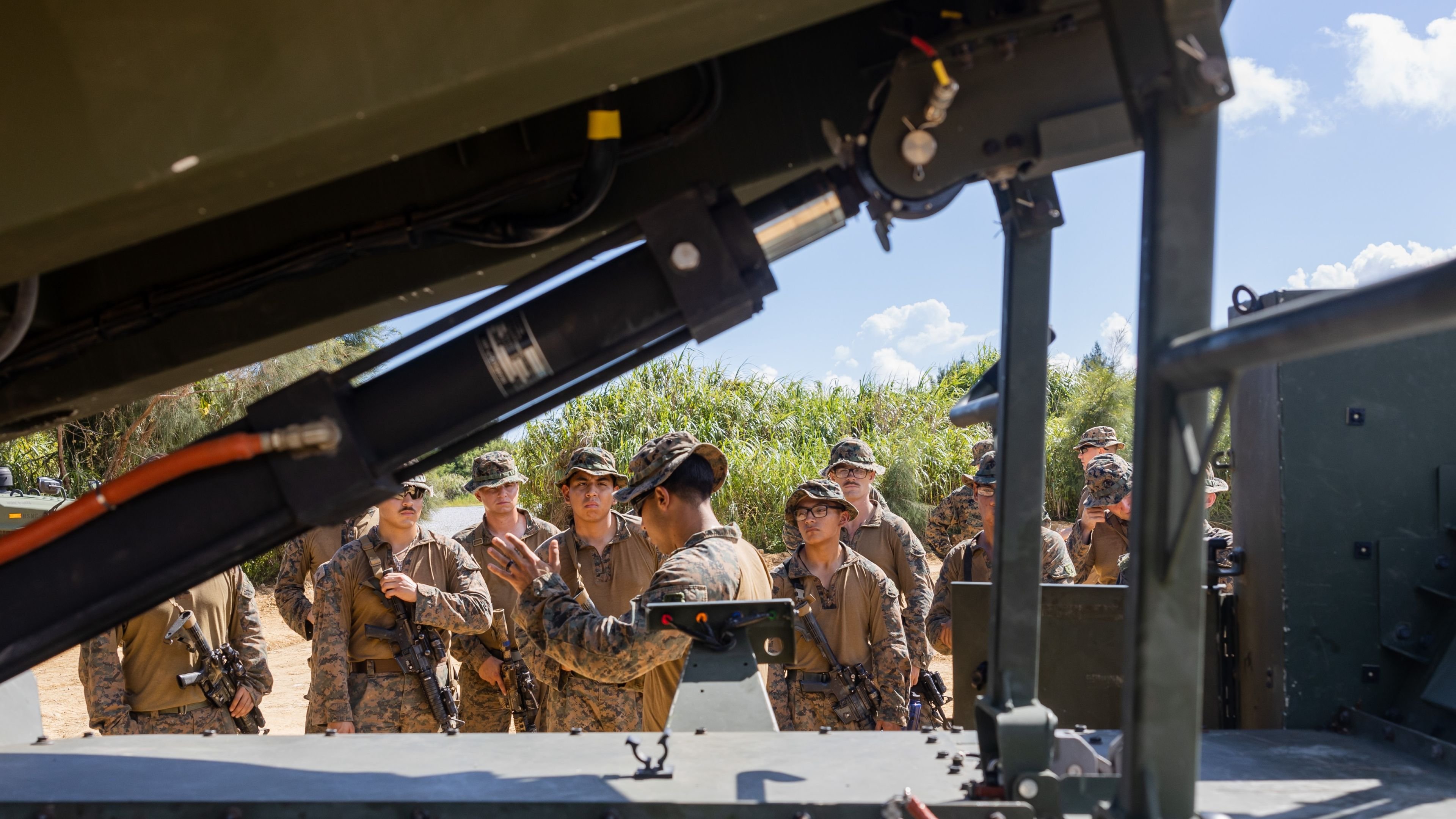 U.S. Marines with 3rd Battalion, 12th Marines, 3rd Marine Division, receive professional military education on the Navy-Marine Expeditionary Ship Interdiction System from Marines with 12th and 3rd Marine Littoral Regiment during Resolute Dragon 25 on Camp Hansen, Okinawa, Japan, Sept. 20, 2025. Resolute Dragon is an annual bilateral exercise in Japan that strengthens the command, control, and multi-domain maneuver capabilities of U.S. Marines in III Marine Expeditionary Force and Japan Self-Defense Force personnel, with a focus on controlling and defending key maritime terrain. (U.S. Marine Corps photo by Cpl. Lucas Lu) 
