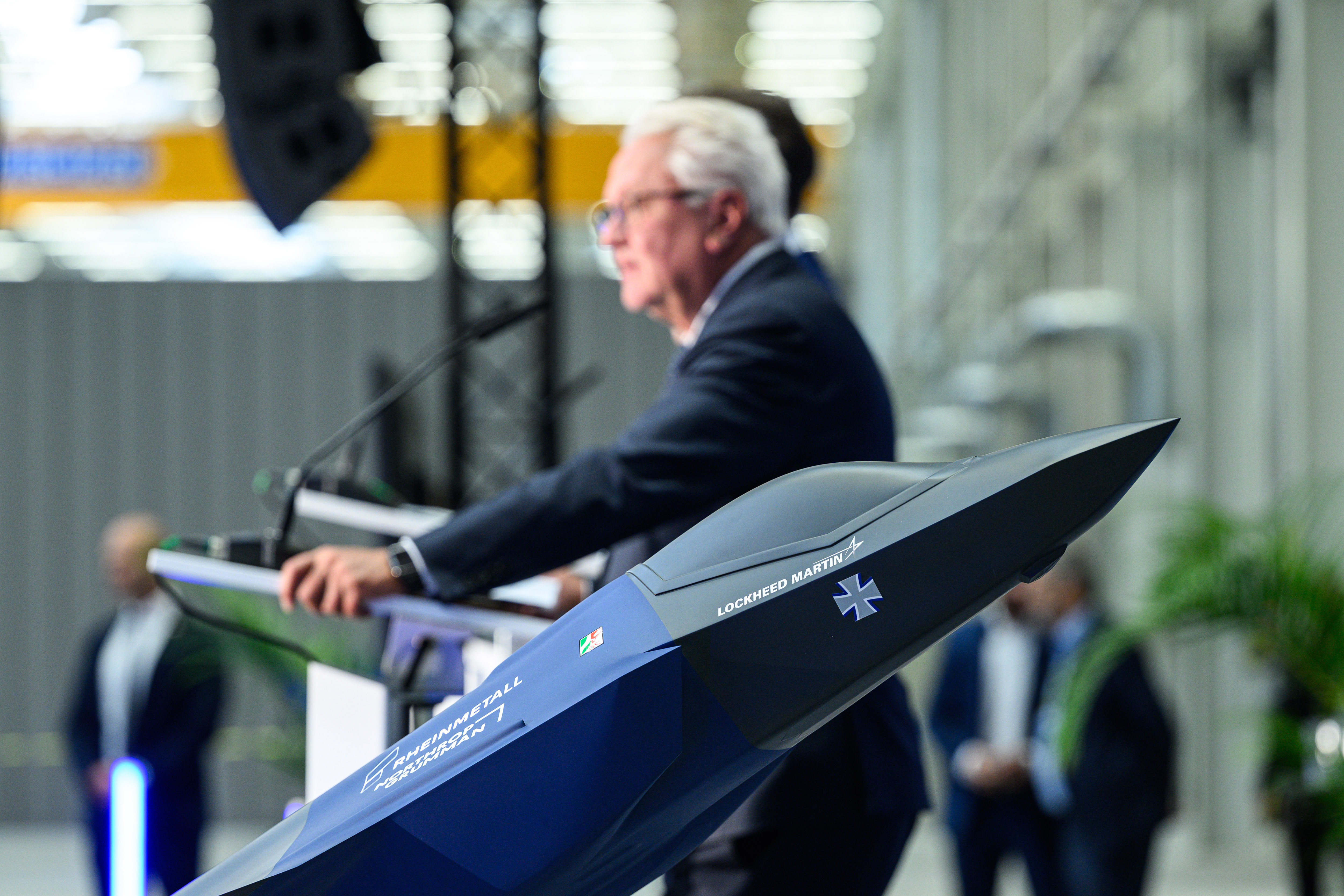 Rheinmetall CEO Armin Papperger stands next to a miniature F-35 inside the hall where company workers will begin manufacturing fuselage sections for the F-35 stealth combat jet on July 1, 2025, in Weeze, Germany. (Lukas Schulze/Getty Images)