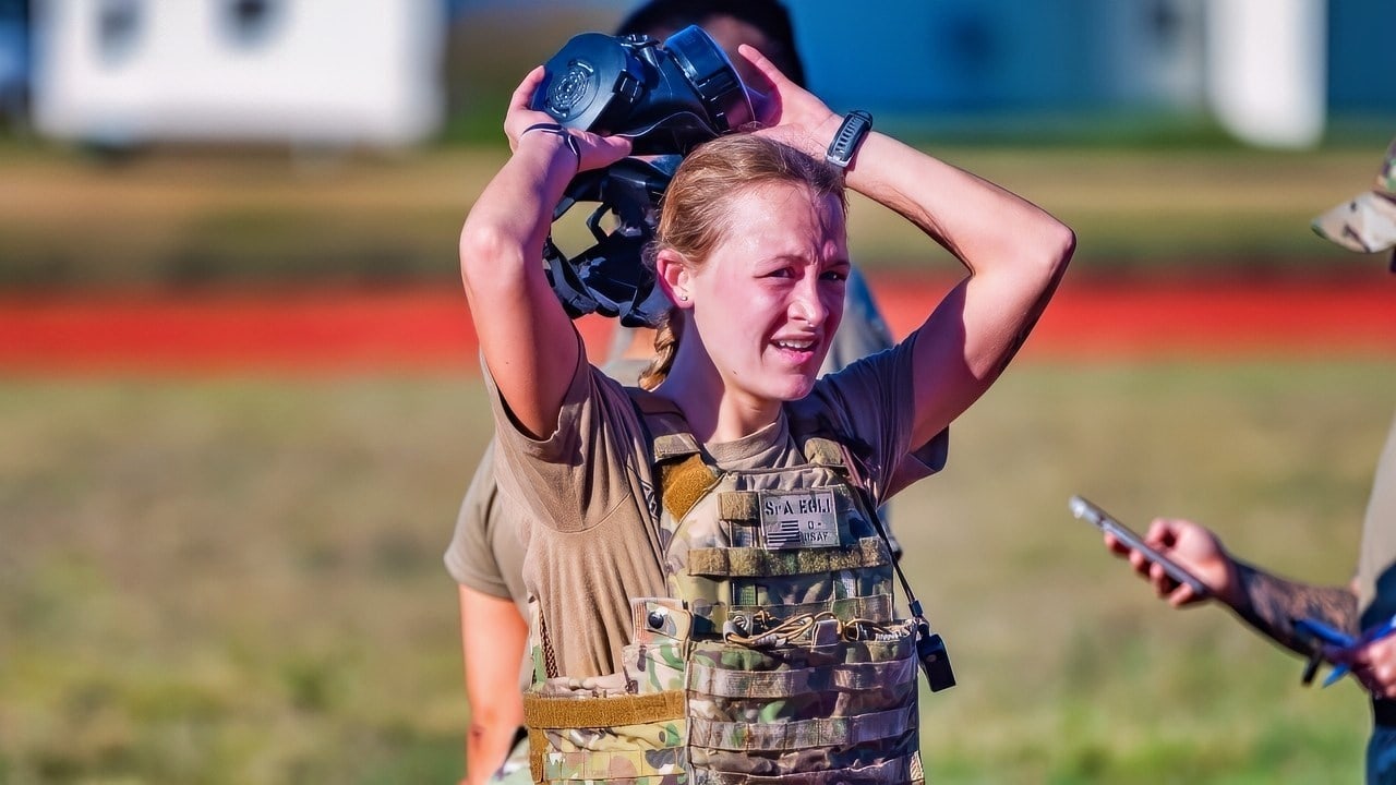 Senior Airman Paige Egli, 90th Security Forces Squadron installation entry controller, takes off her gas mask after running 400 meters during the Crow Creek Challenge at F.E. Warren Air Force Base, Wyoming, Oct. 3, 2025. The Crow Creek Challenge is an annual endurance event where participants ruck across the installation, tackling physical and mental stations designed to boost resilience, teamwork, and operational readiness. (U.S. Air Force photo by Airman Nicholas Rowe)