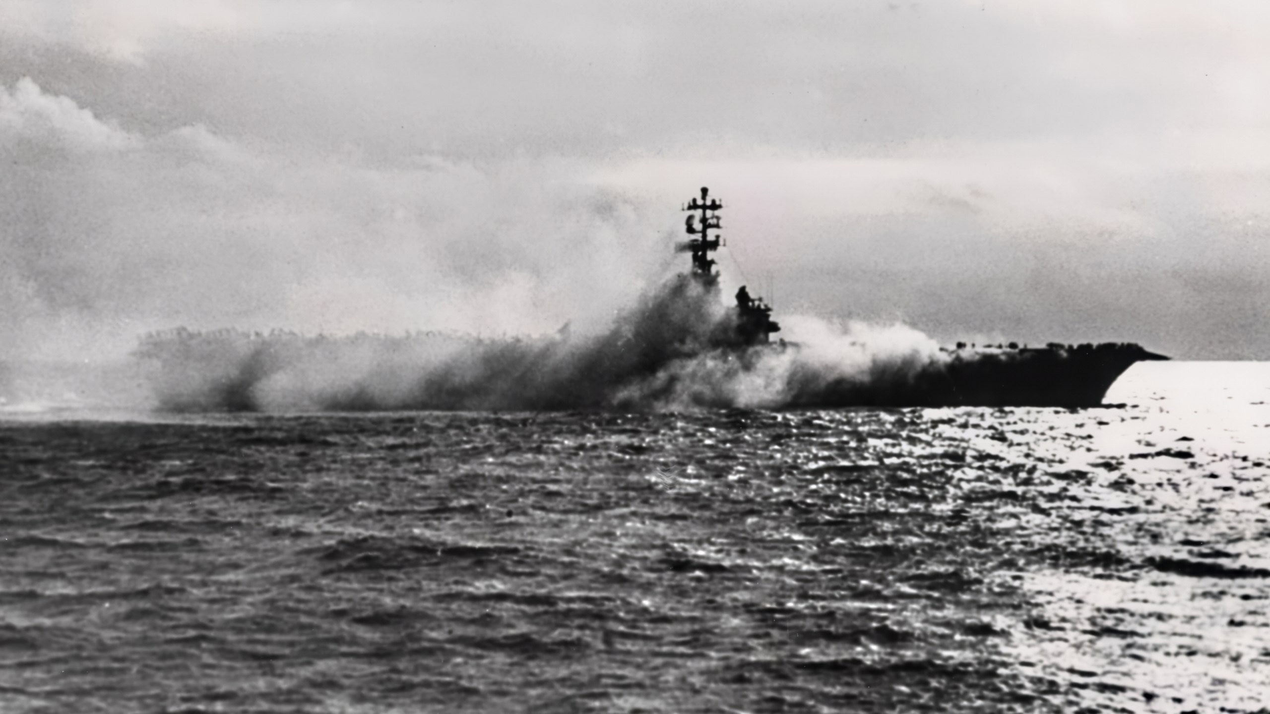 The U.S. Navy aircraft carrier USS Oriskany (CVA-34) on fire, 26 October 1966. Smoke pours from Oriskany's Hangar Bay No.1, during the fire which killed 44 of her officers and men.
