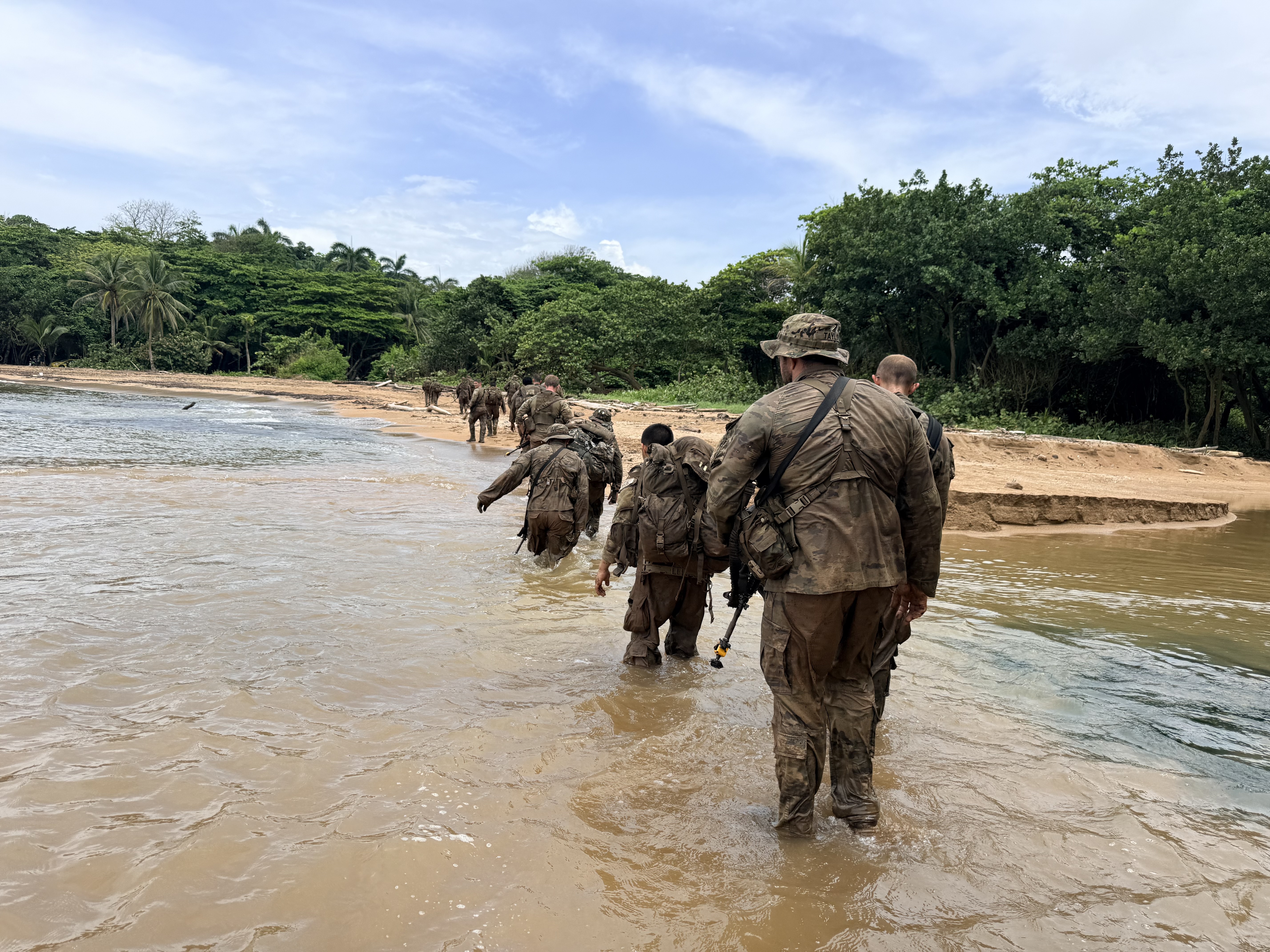 Jungle school participants cross the water's edge to complete the Green Mile. (Eve Sampson/staff)
