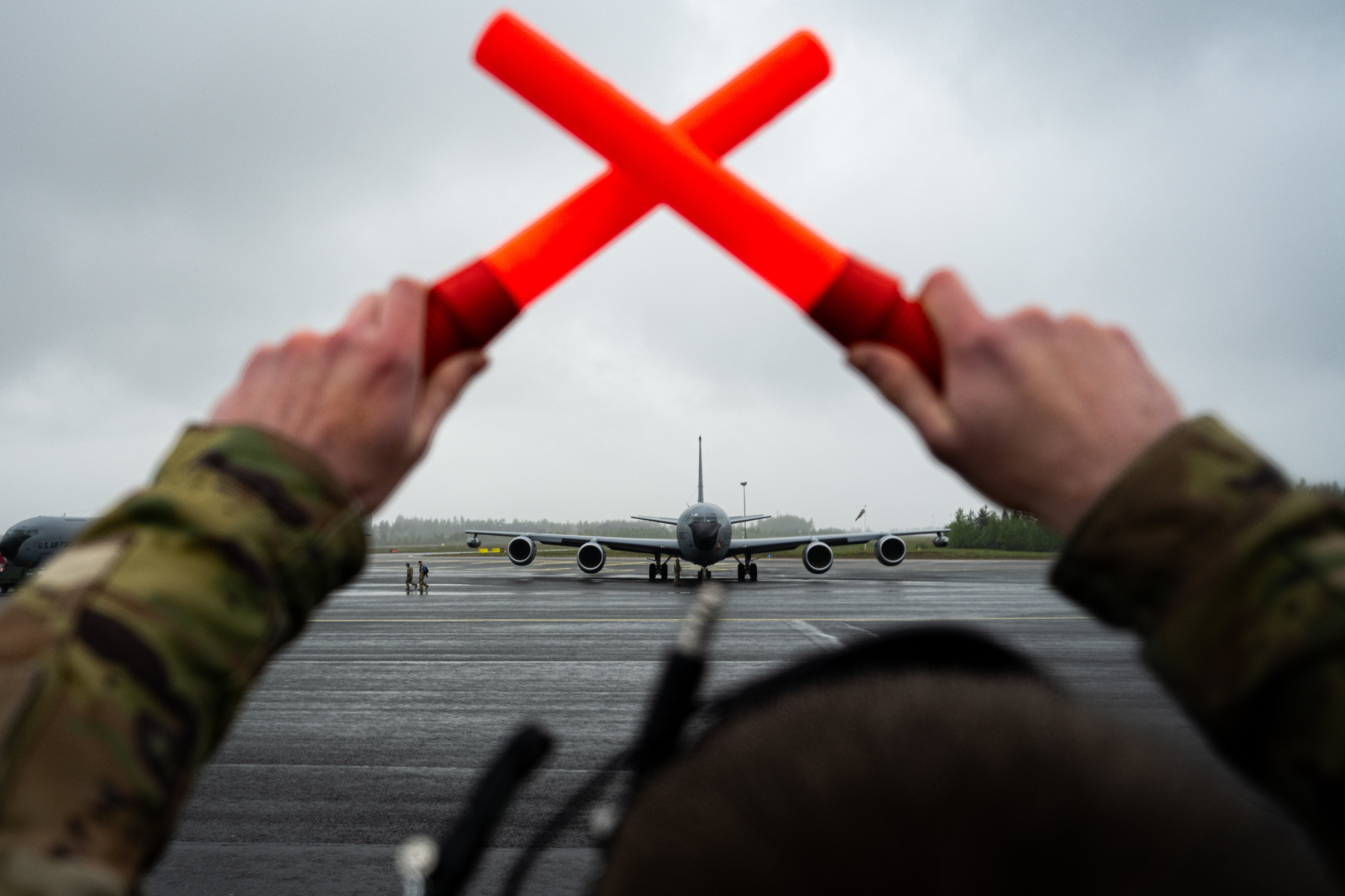 U.S. Air Force Senior Airman Ethan Coleman, 100th Aircraft Maintenance Squadron KC-135 Stratotanker aerospace propulsion journeyman, prepares to marshal a KC-135 Stratotanker during exercise Atlantic Trident 25 at Rovaniemi Air Base, Finland, June 17, 2025. Atlantic Trident 25 allows the U.S., U.K., France and Finland to train in an interoperable environment, refining operational integration and ensuring Allied forces can seamlessly secure the Euro-Atlantic region. (U.S. Air Force photo by Senior Airman Christopher Campbell)