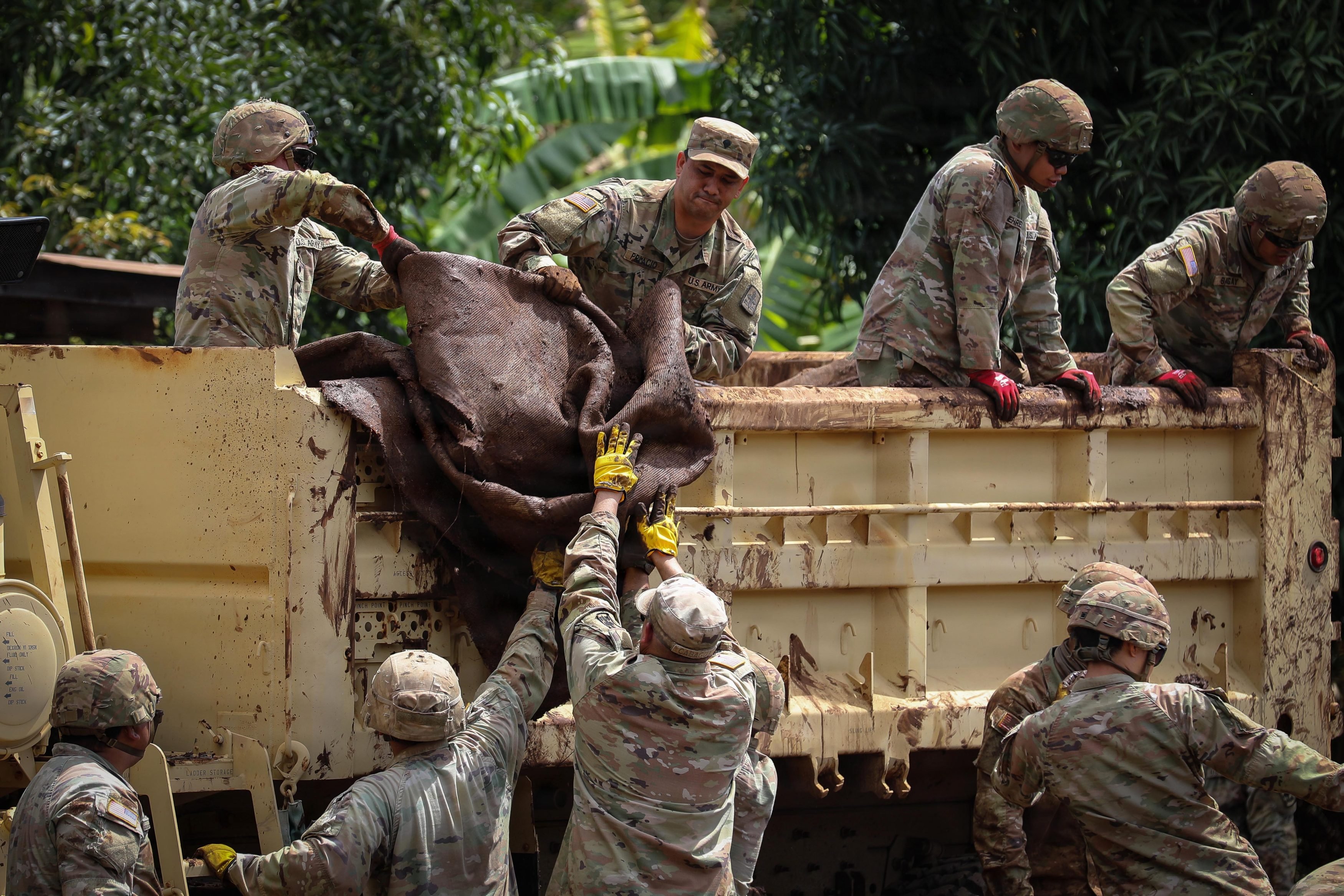 Soldiers and Airmen of the Hawaii National Guard assist the community with flood debris removal in Waialua, Hawaii, March 31, 2026. Hawaii National Guard members are assisting with local recovery efforts by removing debris, clearing mud, and providing potable water to the Waialua community at the request of civil authorities. (U.S. Army National Guard photo by Spc. Daniel Barcenas)