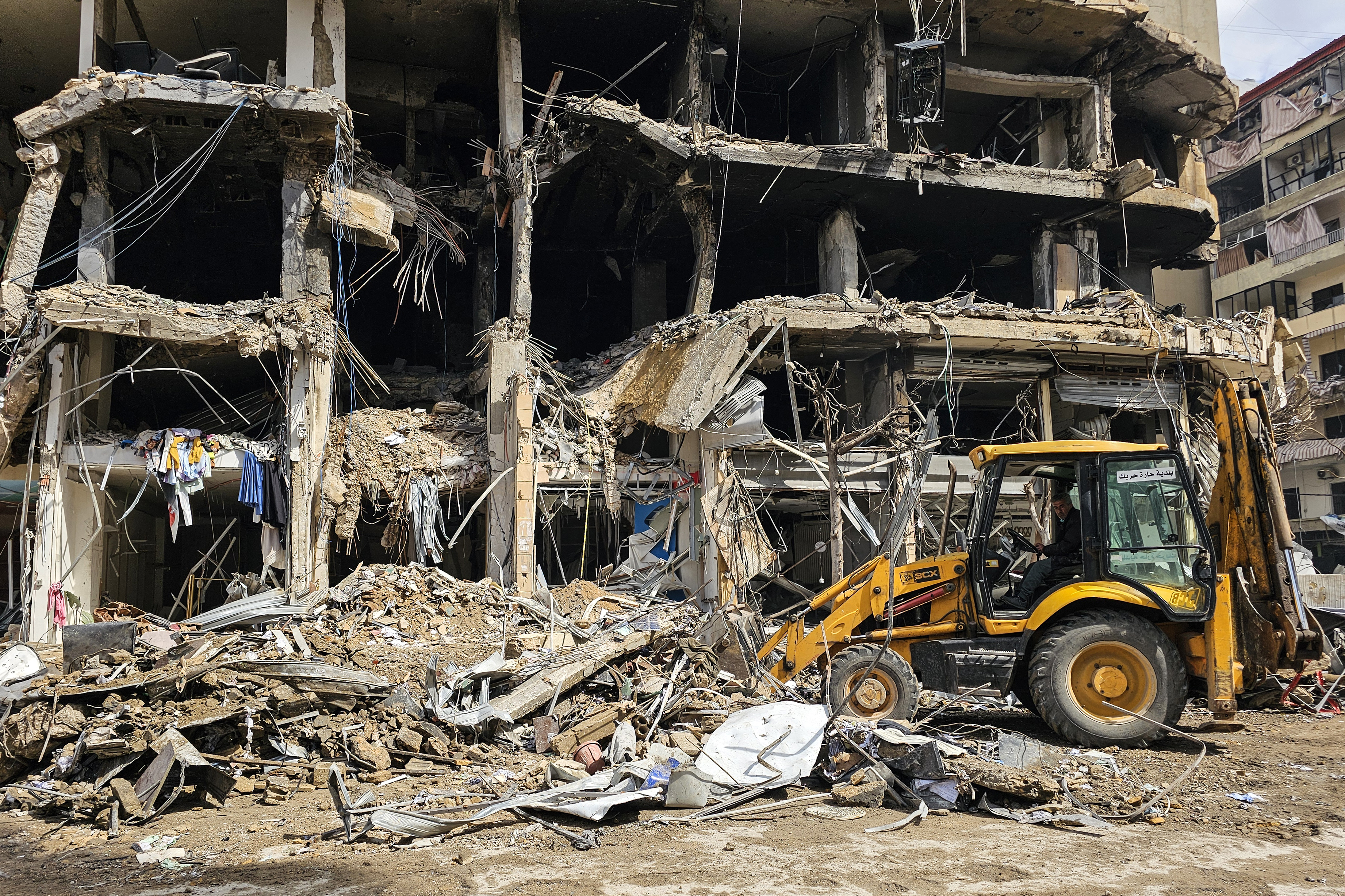 A bulldozer clears rubble from a street at the site of an Israeli airstrike in Beirut's southern suburbs on March 27, 2026.  (AFP via Getty Images)