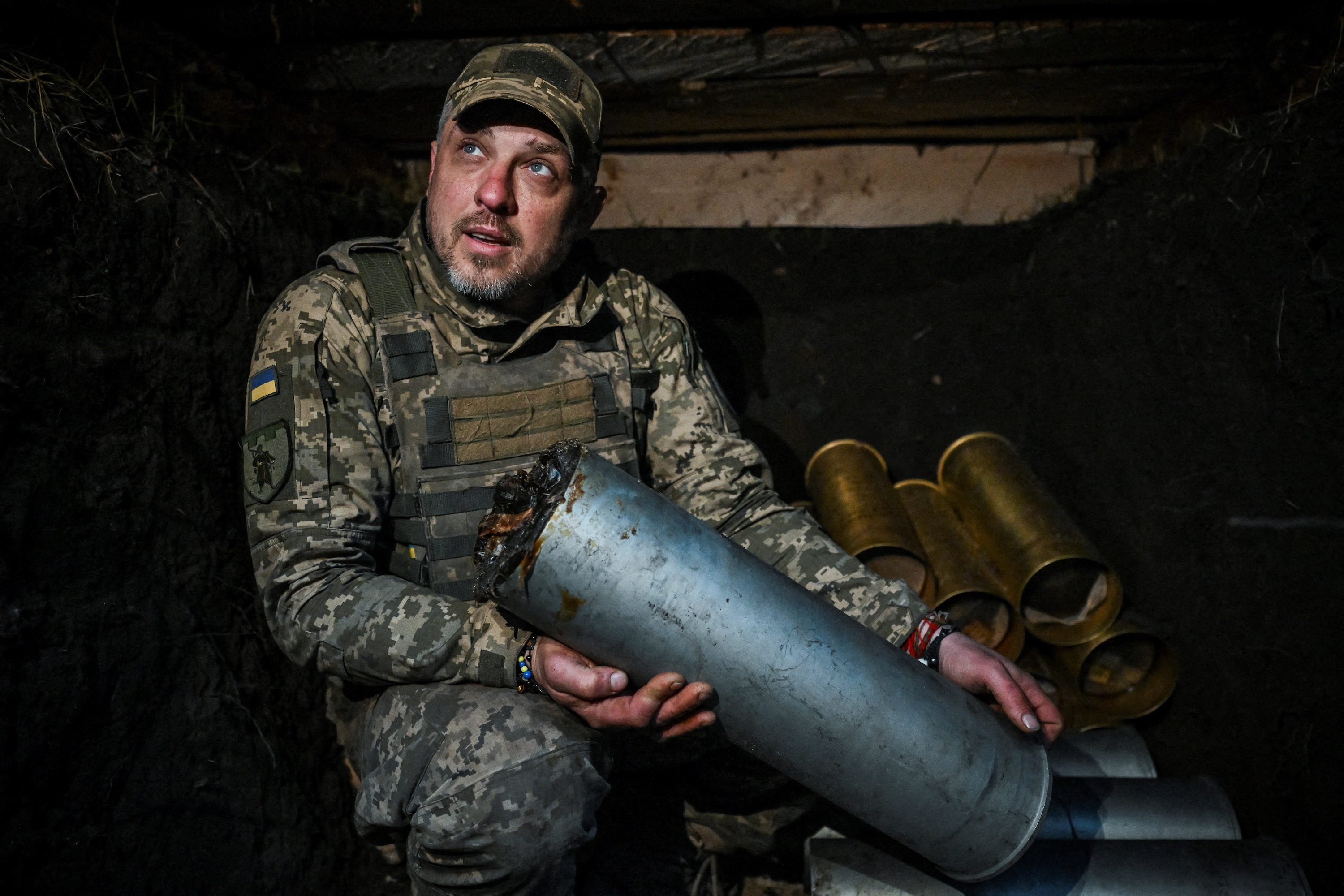 A Ukrainian serviceman appears in a dugout with ammunition before firing toward Russian troops at a front-line position in the Zaporizhzhia region, Ukraine, April 9, 2026. (Stringer/Reuters)