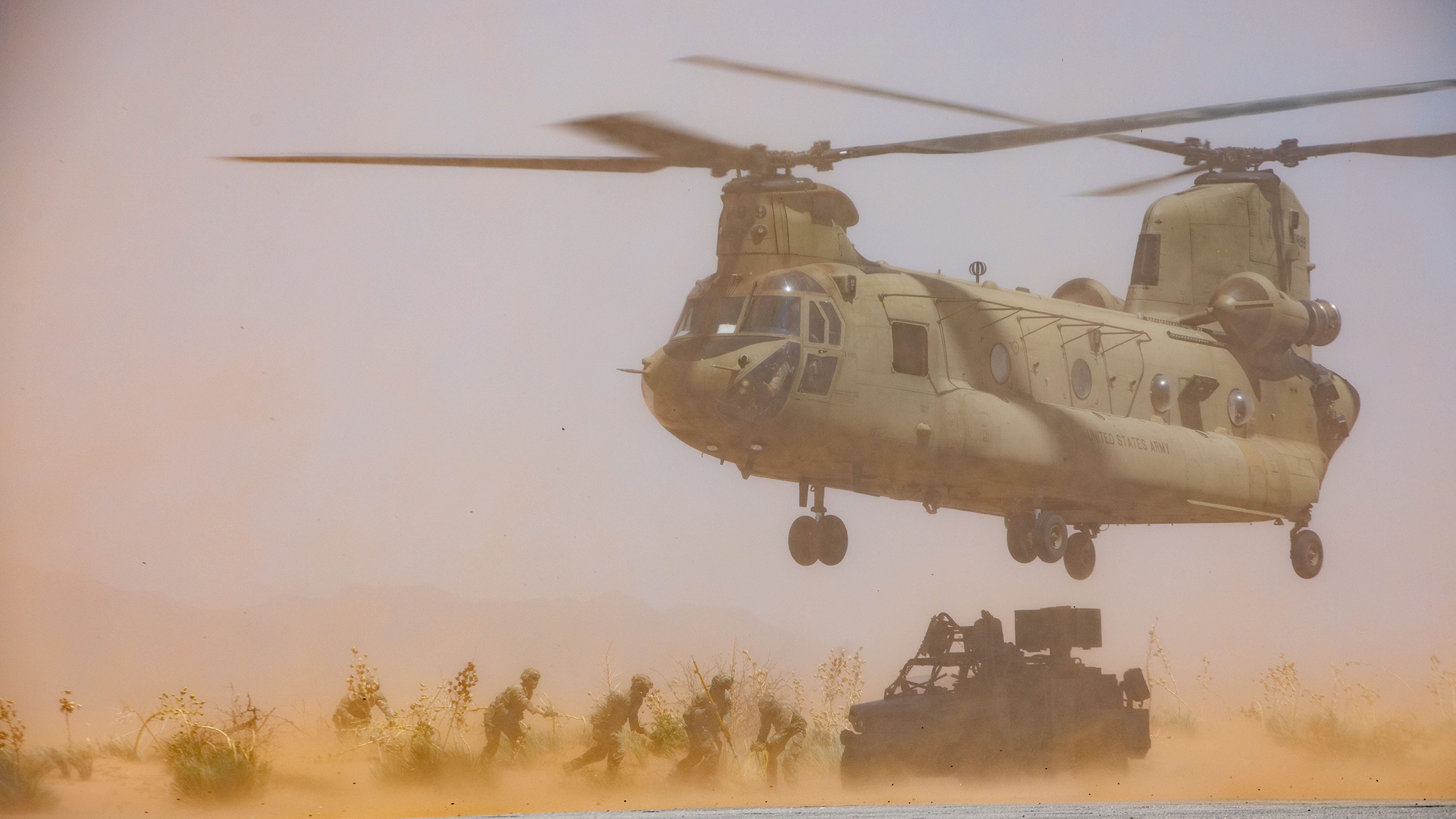 U.S. Soldiers, assigned to Joint Task Force Southern Border, prepare to sling load a All-Terrain M1301 Infantry Squad Vehicle to a CH-47 Chinook during the Air Assault Sustainment Course, at Fort Bliss, Texas, July 16, 2025. Sling load capabilities allow for equipment up to 25,000lbs to be transported by helicopter to remote areas of the border that would be difficult or impossible to travel to otherwise. JTF-SB executes full scale, agile, and all-domain operations in support of U.S. Customs and Border Protection to protect the territorial integrity of the United States and achieve 100% operational control of the southern border. (U.S. Army photo by Staff Sgt. Rynishia Lewis)