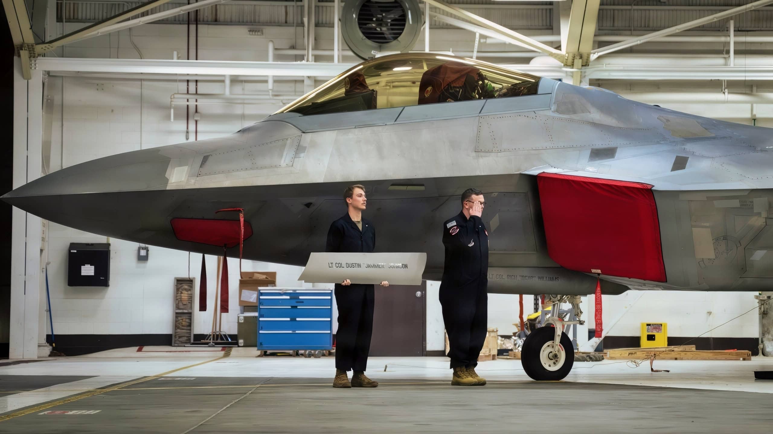 U.S. Air Force Airmen reveal the name of Lt. Col. Richard Williams, commander of the 90th Fighter Squadron, on an F-22 Raptor following the 90th FS change-of-command ceremony on Joint Base Elmendorf-Richardson, Alaska, March 16, 2026. (U.S. Air Force photo by Airman Keola Vischi)