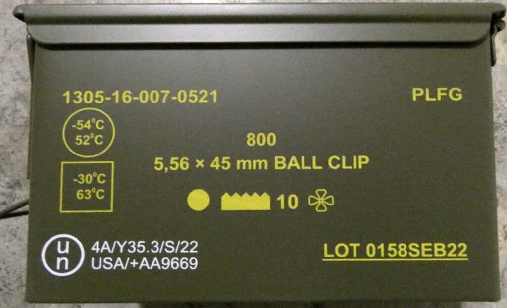 A box of 5.56 mm × 45 NATO rounds, stamped with the NATO interchangeability symbol (AEP-97). [NATO-NAAG-LCGDSS-SG1]