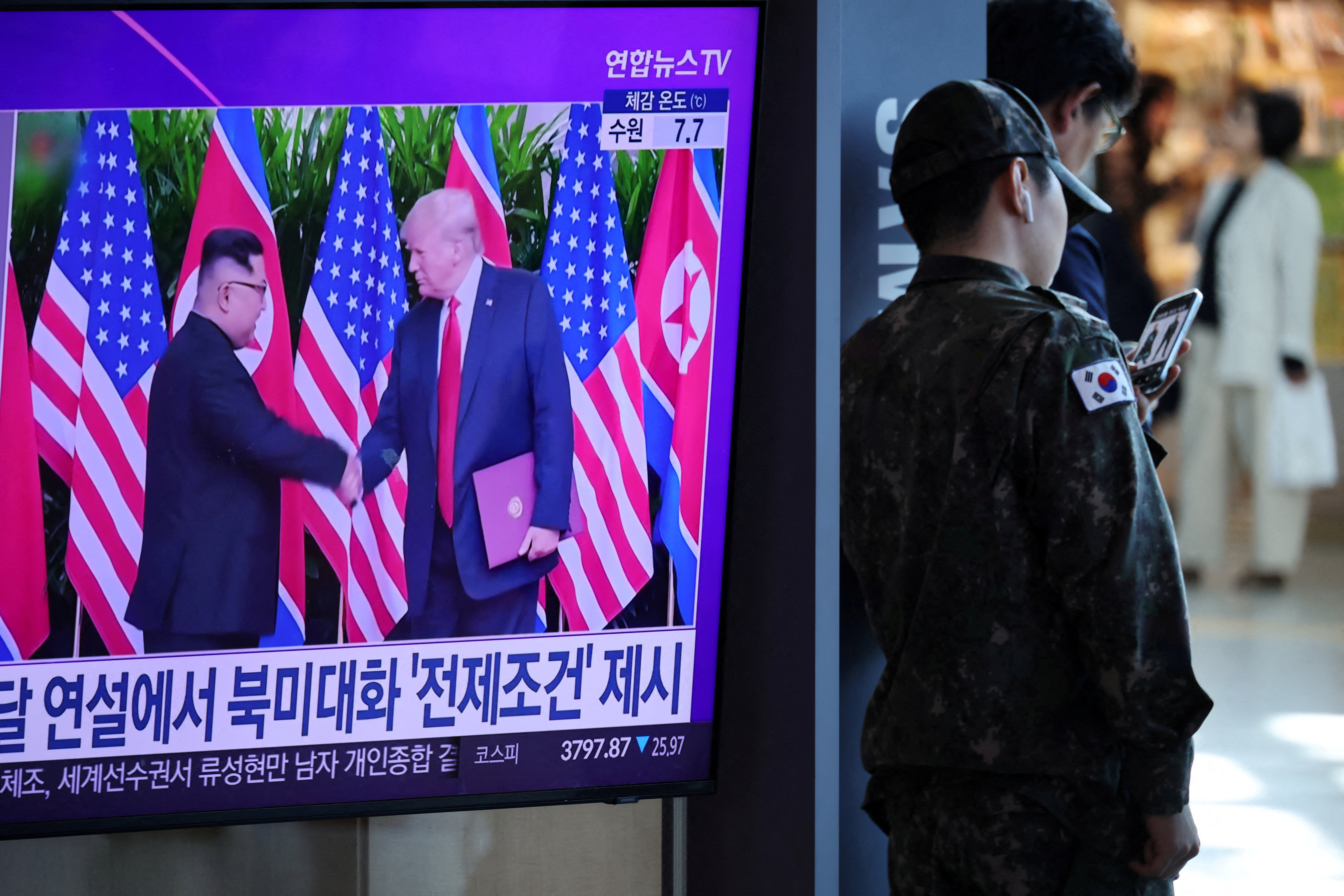 A TV broadcasts a news report on a possible summit between North Korean leader Kim Jong Un and President Donald Trump, at a railway station in Seoul, South Korea, on October 22, 2025. (Kim Hong-Ji/Reuters)