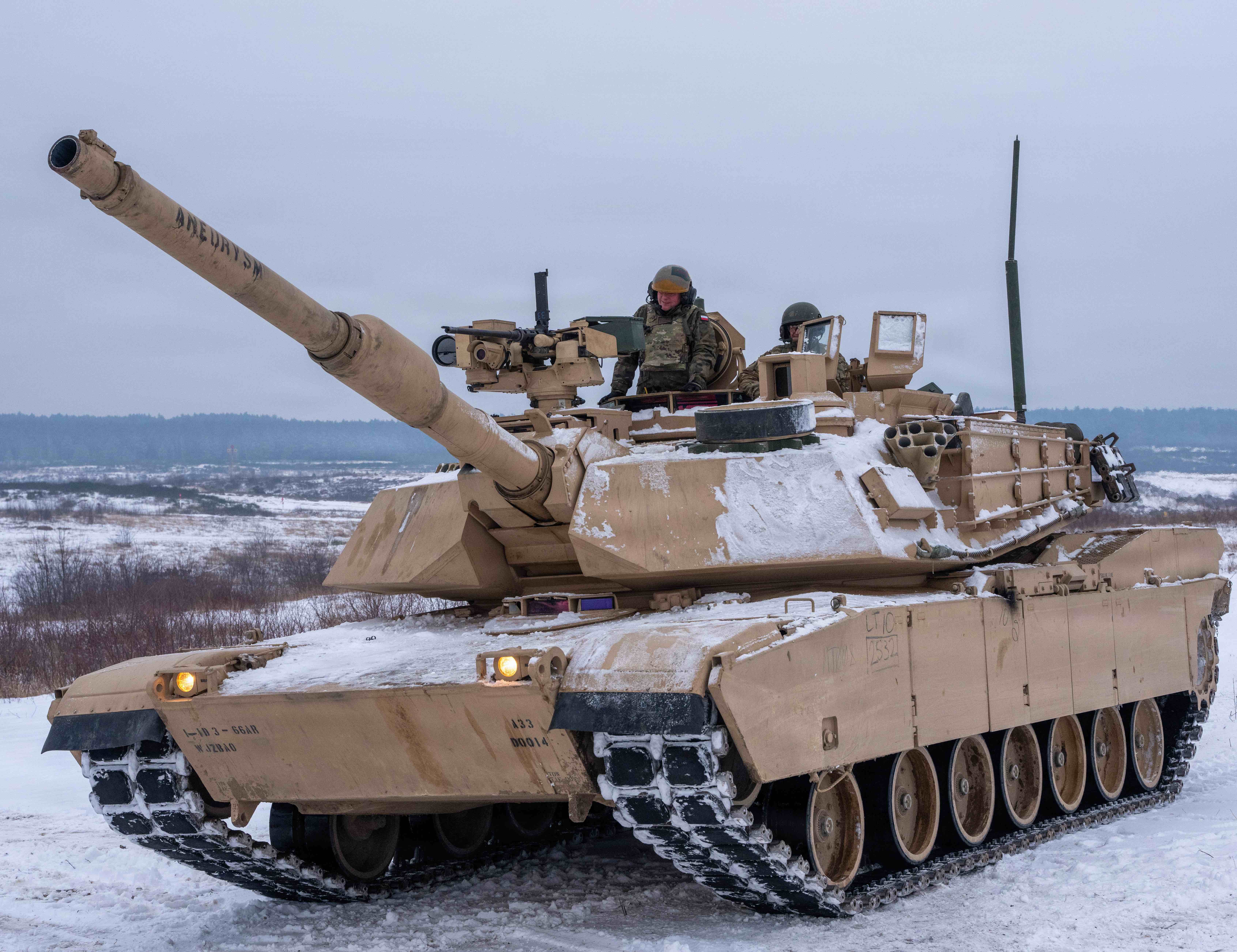 U.S. Army Soldiers assigned to 1st Armored Brigade Combat Team, 1st Infantry Division, welcome Polish Maj. Gen. Maciej Jablonski, Deputy Commanding General- Interoperability U.S. Army V Corps, to fire the U.S. M1A2 Abrams Tank during a live fire exercise at Drawsko Combat Training Center, Poland, Jan. 13, 2026. The event highlighted the importance of mechanized forces in reinforcing NATO’s defensive posture in Poland. U.S. and NATO forces in Europe conduct ongoing joint training exercises to strengthen interoperability and ensure collective defense readiness. (U.S. Army photo by Sgt. Dakota Bradford)