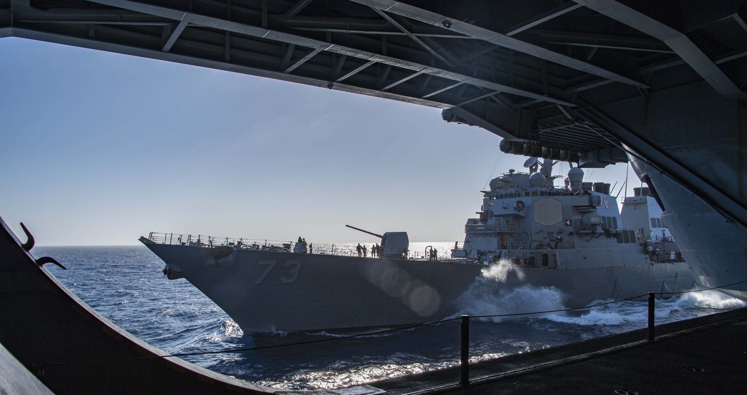 (Aug. 28, 2023) The Arleigh Burke-class guided-missile destroyer USS Decatur (DDG 73) steams alongside the aircraft carrier USS Nimitz (CVN 68) . Nimitz is underway conducting routine operations. (U.S. Navy photo by Mass Communication Specialist Seaman Tomas Valdes)