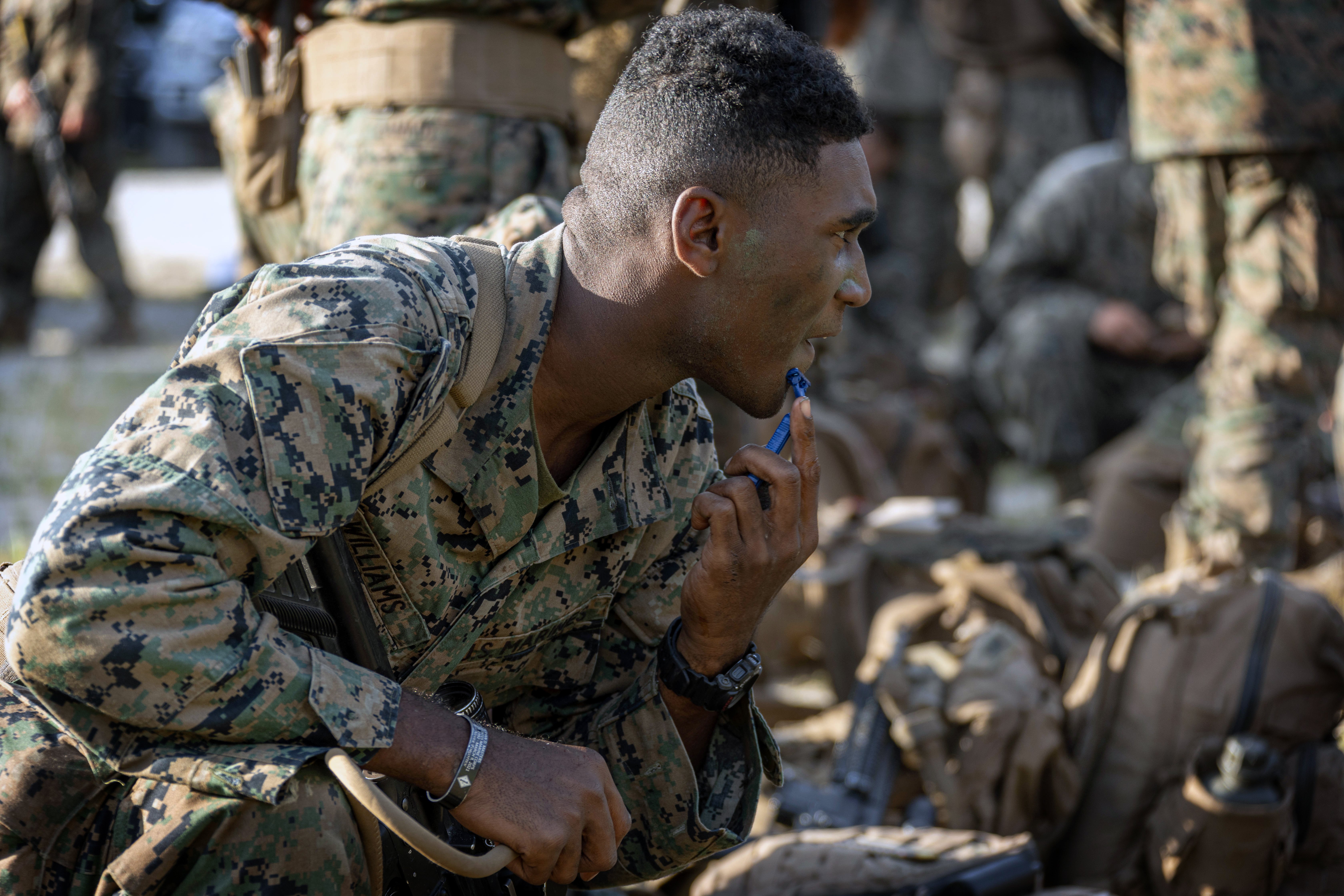 A U.S. Marine assigned to Delta Company, Infantry Training Battalion, School of Infantry – East shaves during the culminating event of the Infantry Marine Course at Camp Lejeune, North Carolina, Sept. 12, 2024. The Infantry Marine Course is the Marine Corps’ entry-level training course for enlisted infantry Marines. (U.S. Marine Corps photo by Chief Warrant Officer 2 Bryan Nygaard)