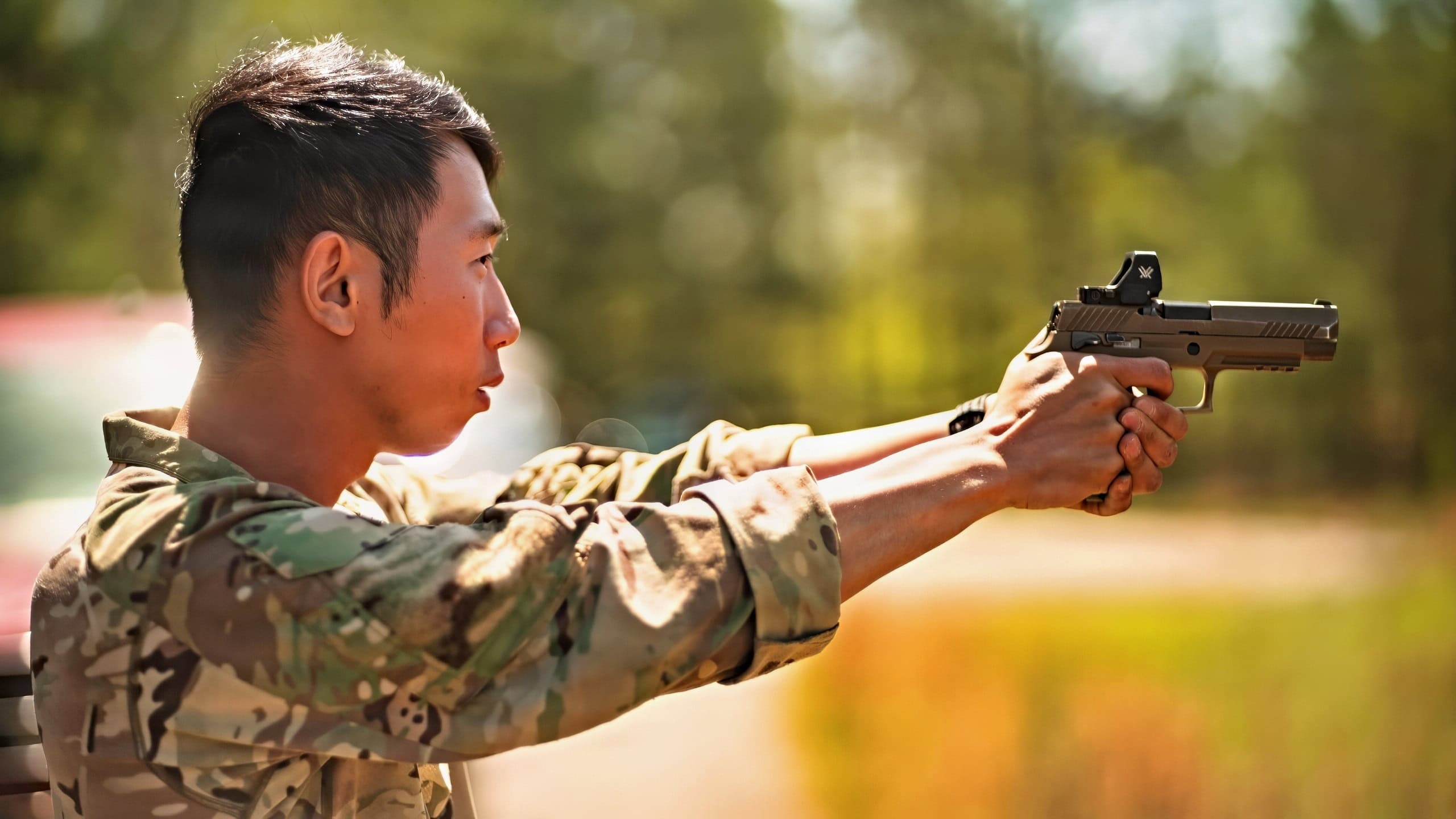 U.S. Army Sgt. Gengyang Jiang, assigned to Headquarters and Headquarters Company, 1st Battalion, 18th Infantry Regiment, 1st Infantry Division, practiced aiming a SIG Sauer M17 pistol for one of the International Sniper competition events at Fort Benning, Ga., April 9, 2026. The International Sniper Competition tests elite teams in a rigorous gauntlet of events including long-range marksmanship, stealth movement, and reconnaissance and reporting ability. (U.S. Army photo by Sgt. Chase Murray)