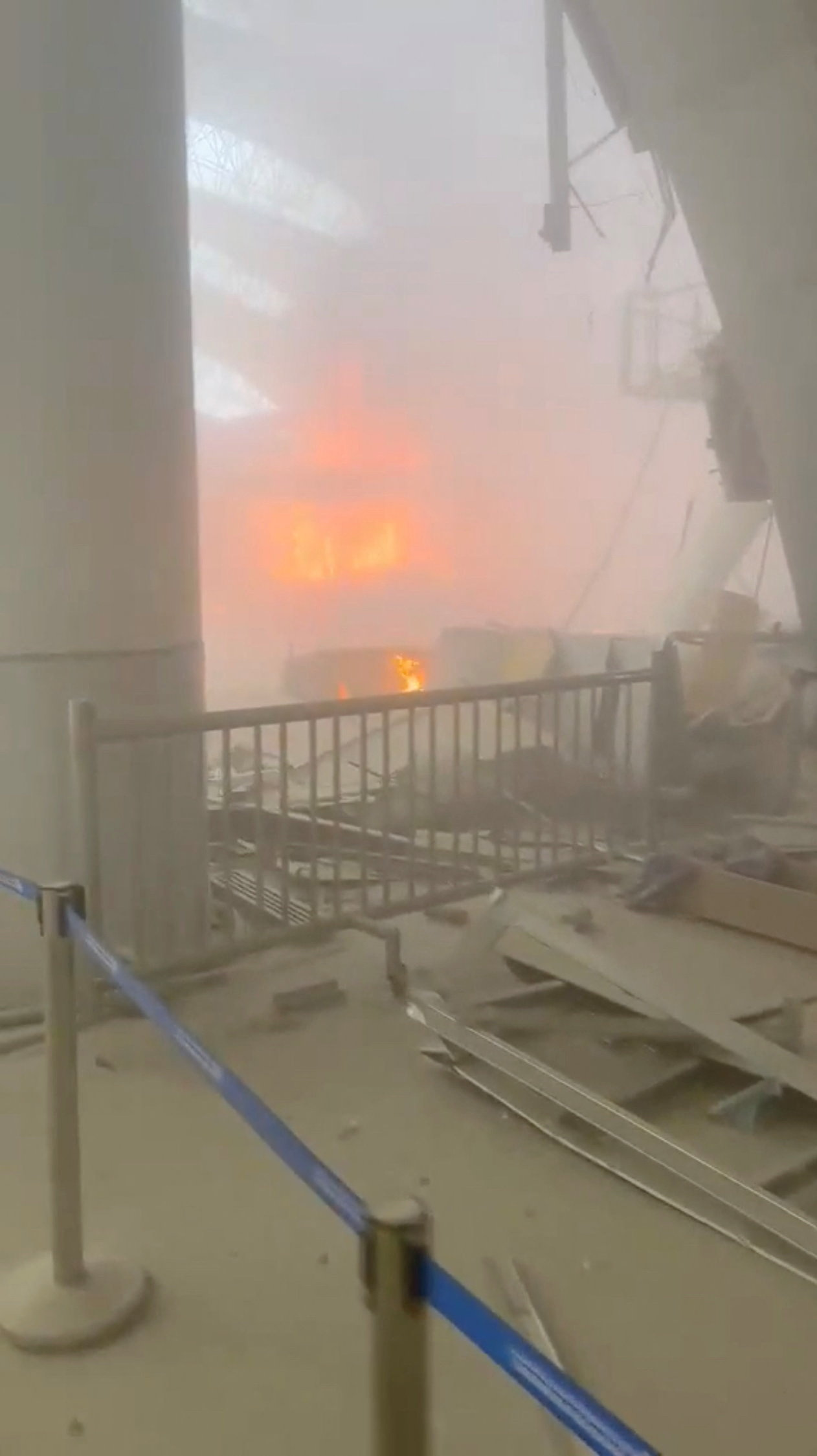 Debris lies on the floor as fire burns in the background in the aftermath of Iranian strikes on Kuwait International Airport in Kuwait City, Kuwait, on June 3, 2026. (Reuters) 