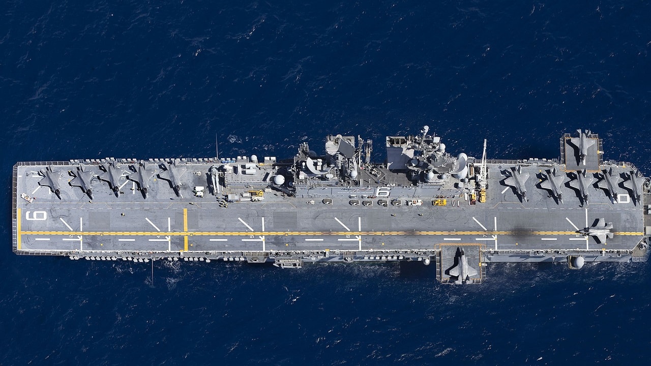 Thirteen U.S. Marine Corps F-35B Lightning II with Marine Fighter Attack Squadron (VMFA) 122, Marine Aircraft Group 13, 3rd Marine Aircraft Wing (MAW), are staged aboard the amphibious assault ship USS America (LHA 6) as part of routine training in the eastern Pacific, Oct. 8, 2019. Integrating 3rd MAW’s combat power and capabilities while conducting realistic training is essential to generate readiness and lethality in our units. (U.S. Marine Corps photo illustration by Lance Cpl. Juan Anaya)