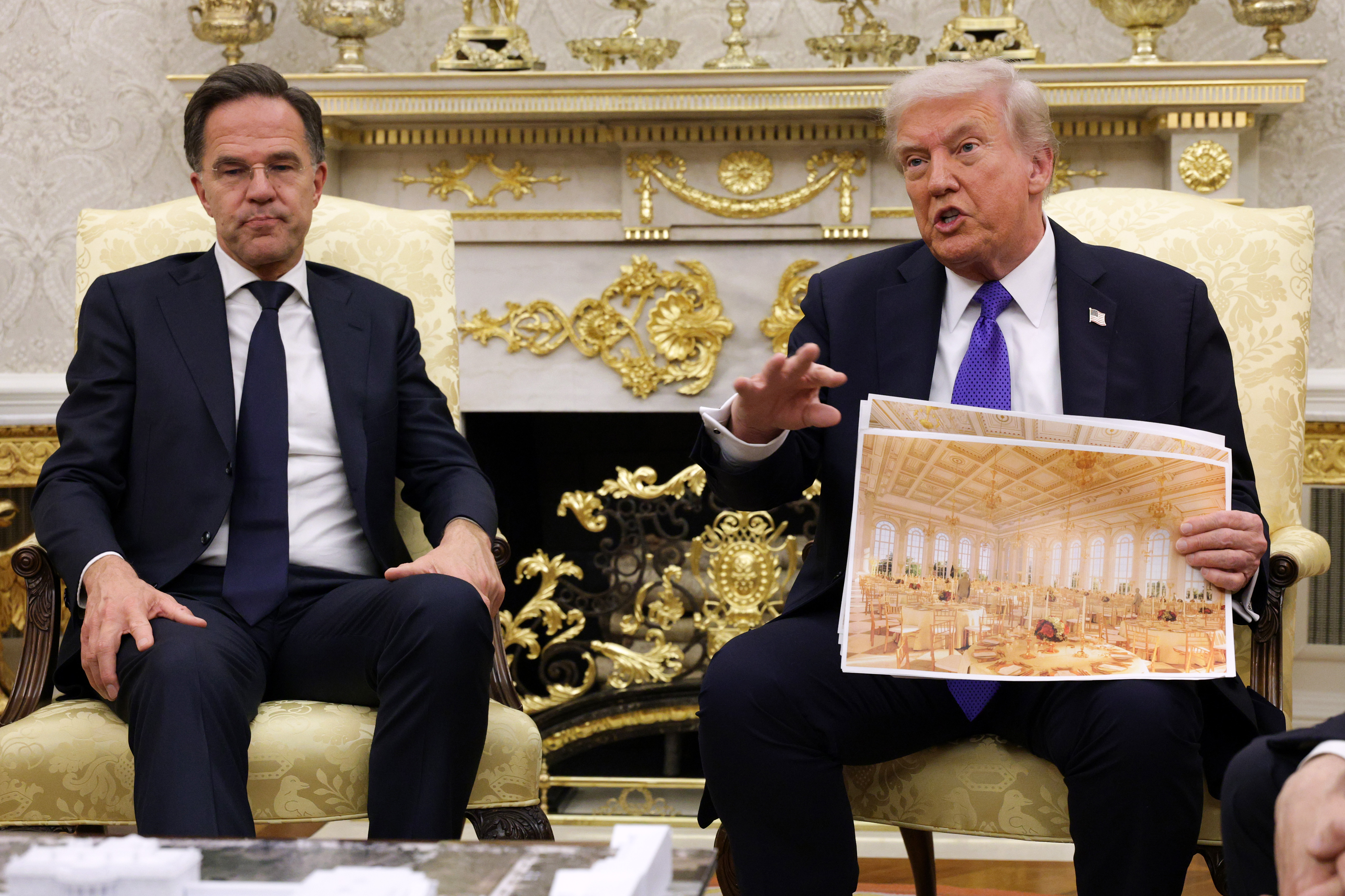 U.S. President Donald Trump displays a rendering of his proposed White House ballroom as he meets with NATO Secretary General Mark Rutte (L) in the Oval Office of the White House on Oct. 22, 2025, in Washington, DC. (Photo by Alex Wong/Getty Images)