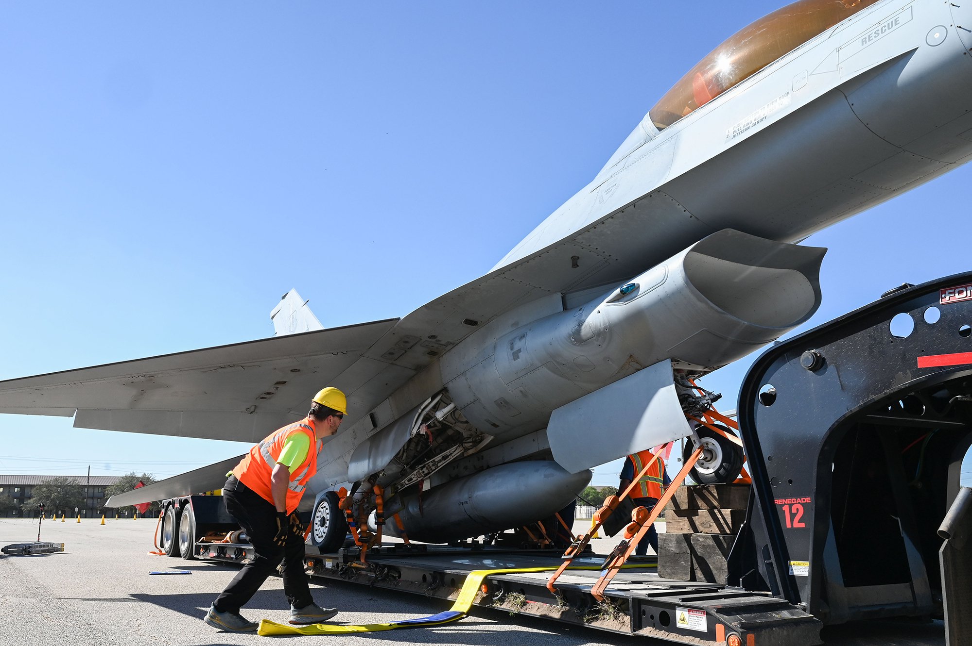 An F-16 Fighting Falcon is hauled by an 18-wheeler through Joint Base San Antonio-Lackland, Texas, March 20, 2026. 