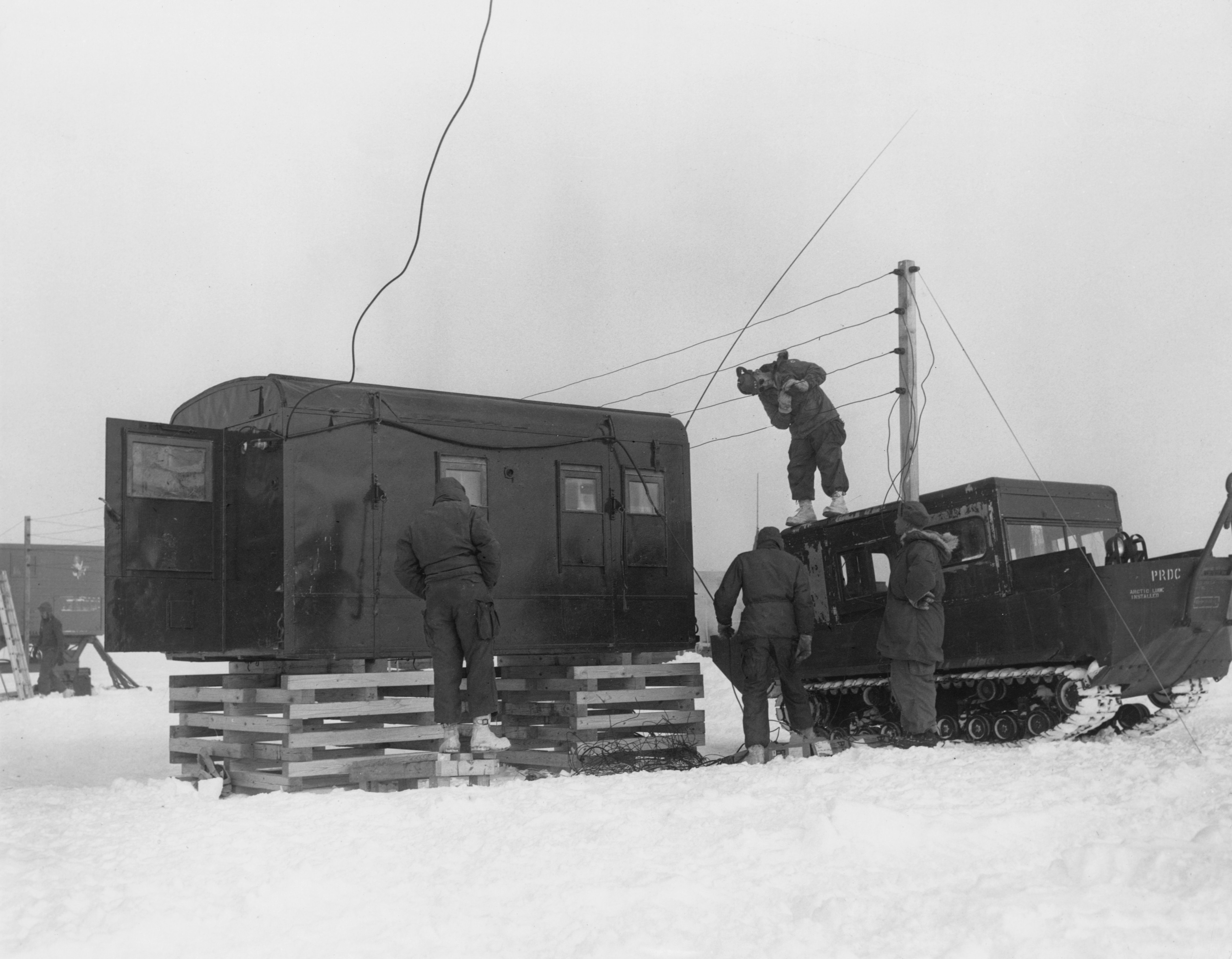 Men of the U.S. Army Polar Research and Development Center set up communications at the temporary camp used during the construction of Camp Century. (U.S. Army/Pictorial Parade/Archive Photos/Getty Images)