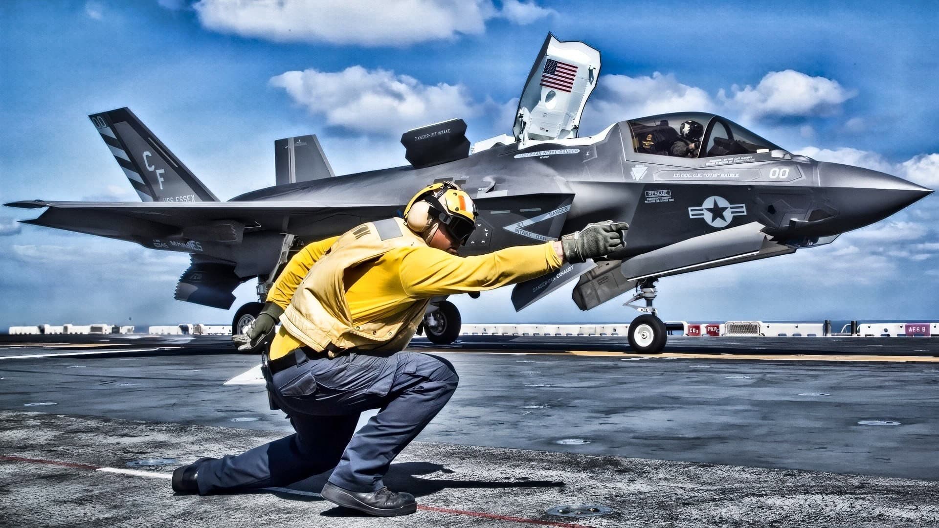 GULF OF ADEN - U.S. Navy Petty Officer 1st Class Rey White, an aviation boatswains mate handler with the Essex Amphibious Ready Group (ARG), launches an F-35B Lightning II from the Wasp-class amphibious assault ship USS Essex (LHD 2), Sept. 22, 2018. The Essex is the flagship for the Essex ARG and, with the embarked 13th Marine Expeditionary Unit, is deployed to the U.S. 5th Fleet area of operations in support of naval operations to ensure maritime stability and security in the Central Region, connecting the Mediterranean and the Pacific through the western Indian Ocean and three strategic choke points. (U.S. Marine Corps photo by Cpl. Francisco J. Diaz Jr./Released)