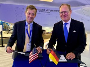GA-ASI CEO Linden Blue (left) and INTEC Group CEO Christoph Otten sign an MOU during ILA Berlin.  [Photo © General Atomics Aeronautical Systems, Inc.]