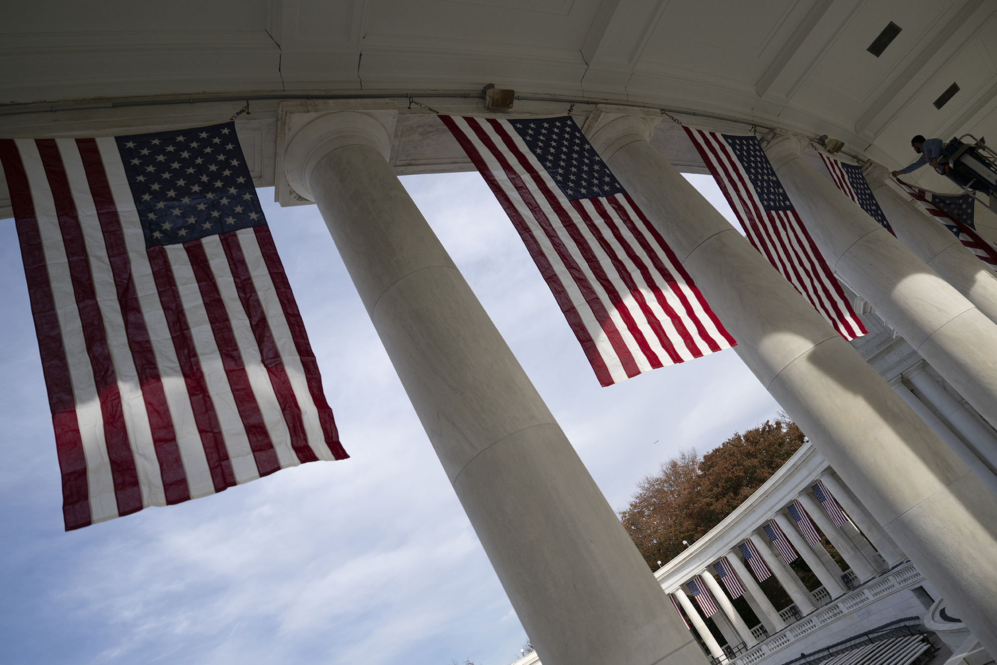 Arlington National Cemetery Facilities Maintenance employees hang U.S. flags in the Memorial Amphitheater in preparation for the National Veterans Day Observance, Arlington National Cemetery, Arlington, Virginia, Nov. 4, 2024. (U.S. Army photo by Elizabeth Fraser / Arlington National Cemetery)