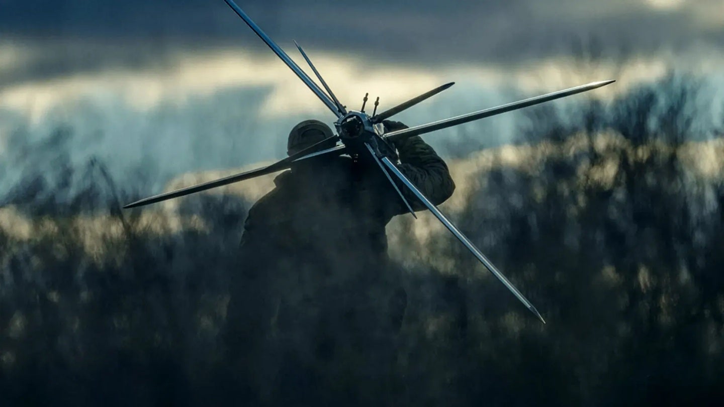 Soldier launching fixed-wing tactical drone in field