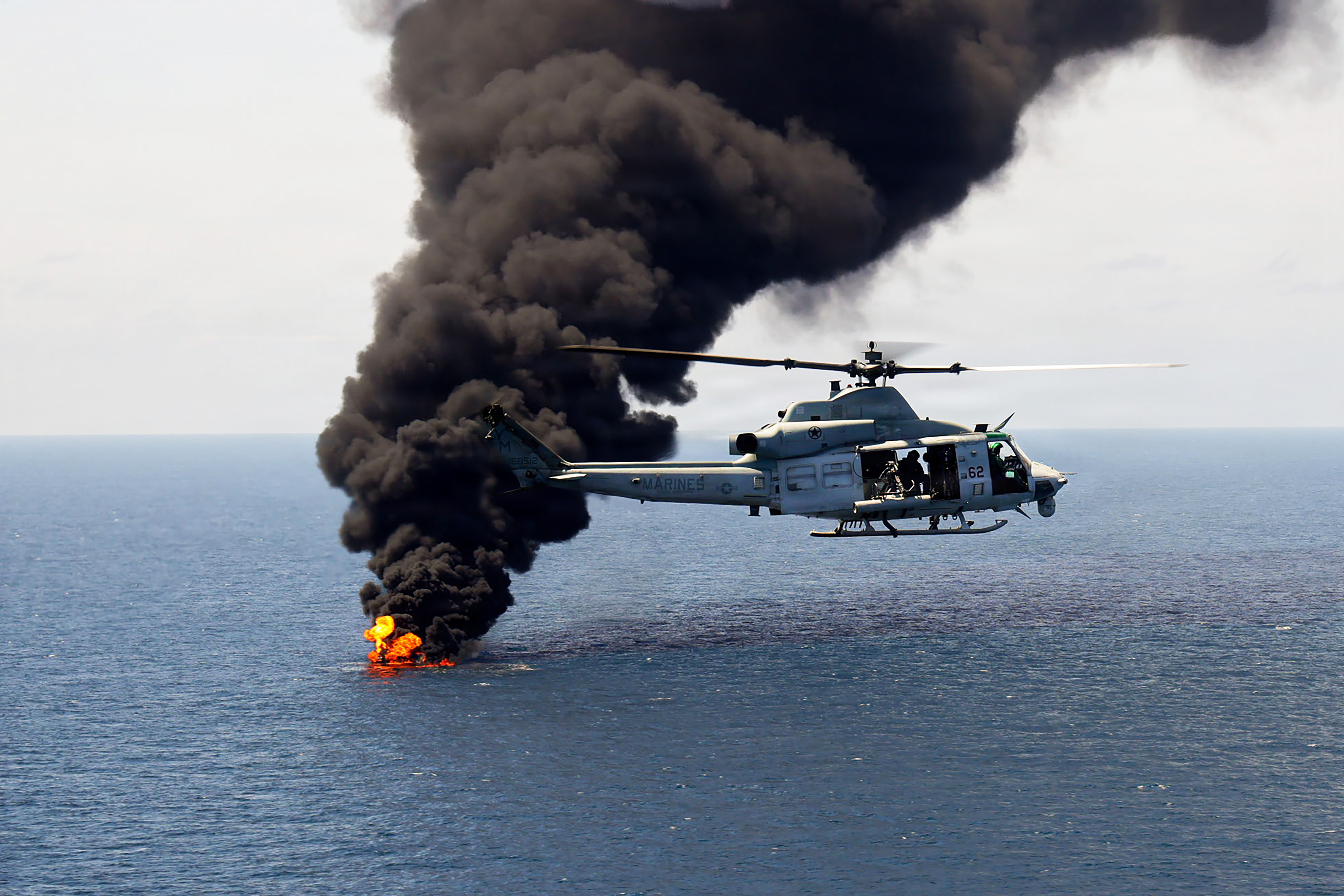 A U.S. Marine Corps UH-1Y Venom flies over a vessel of interest being destroyed during a Maritime Interdiction Operation in the Pacific Ocean on Sept. 5, 2026. The vessel of interest was boarded and cleared before being destroyed. (U.S. Marine Corps)
