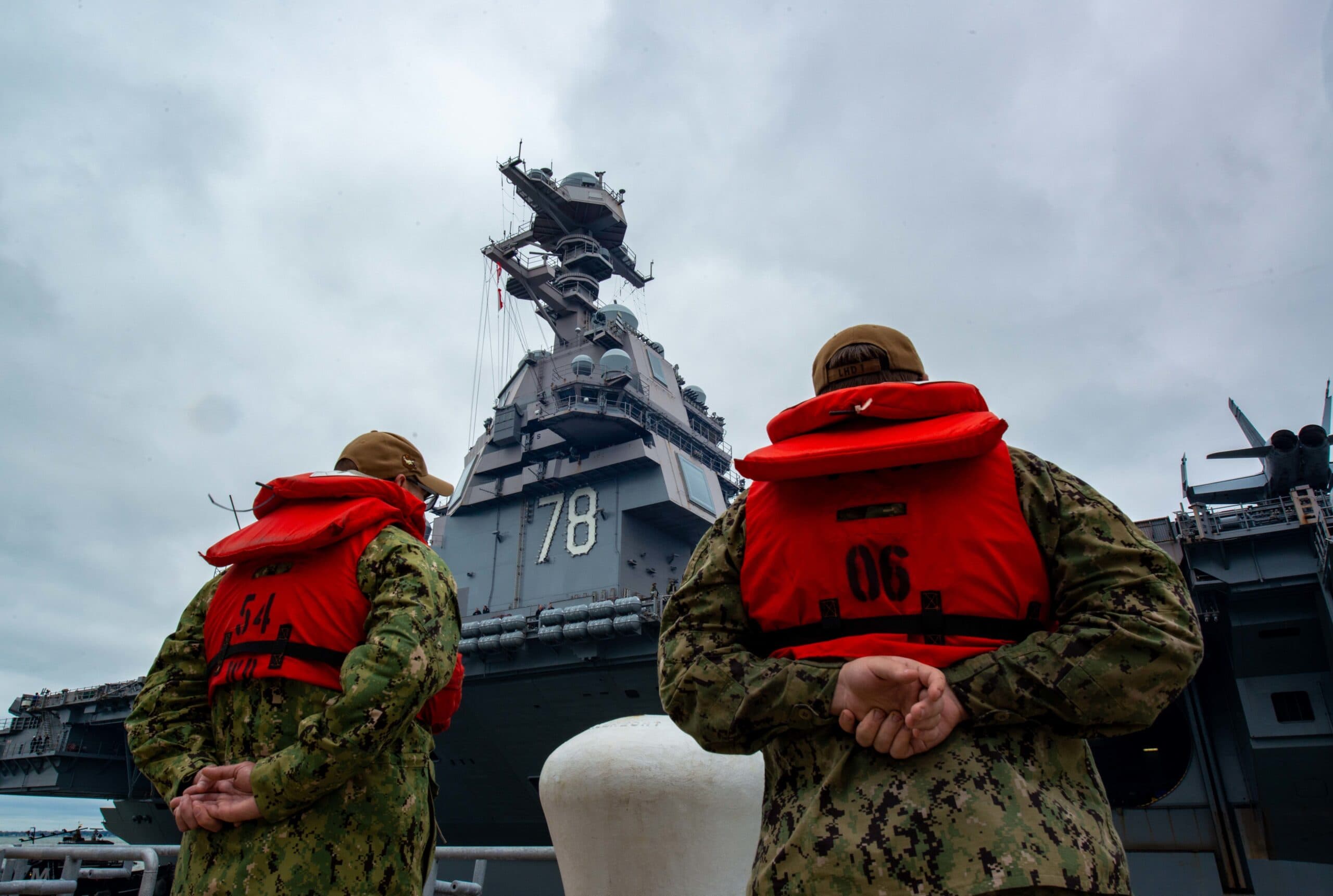 NORFOLK, Va. (Oct. 4, 2022) Sailors stand at parade rest as the first-in-class, Ford class aircraft carrier USS Gerald R. Ford (CVN 78) departs Naval Station Norfolk on its first deployment, Oct. 4, 2022. The Gerald R. Ford Carrier Strike Group (GRFCSG) is deployed in the Atlantic Ocean, conducting training and operations alongside NATO Allies and partners to enhance integration for future operations and demonstrate the U.S. Navy's commitment to a peaceful, stable and conflict-free Atlantic region. (U.S. Navy photo by Mass Communication Specialist 3rd Class Thomas Boatright)