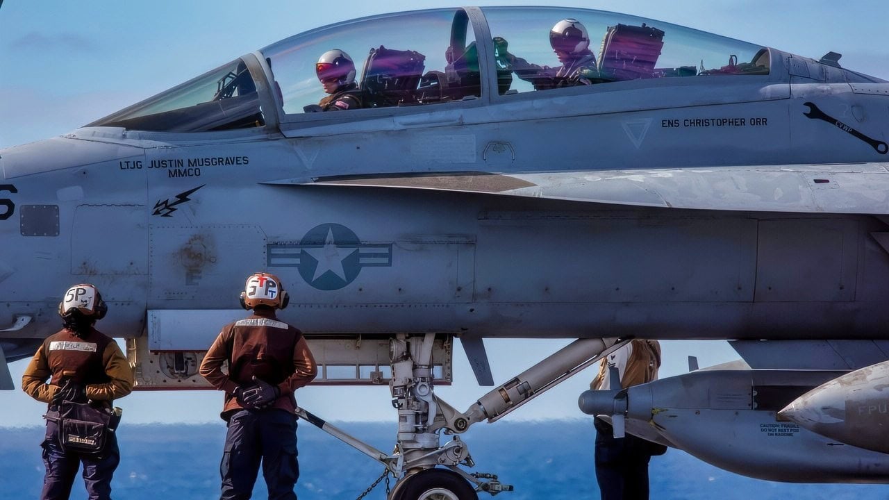 U.S. Navy Sailors prepare to taxi an EA-18G Growler, attached to Electronic Attack Squadron (VAQ) 133, on the flight deck of Nimitz-class aircraft carrier USS Abraham Lincoln (CVN 72) on Nov. 24, 2025. USS Abraham Lincoln (CVN 72), flagship of the Abraham Lincoln Carrier Strike Group, is underway conducting routine operations in the U.S. 3rd Fleet area of operations, demonstrating the U.S. Navy’s long-term commitment to a free and open Indo-Pacific. (U.S. Navy photo by Mass Communication Specialist Seaman Daniel Kimmelman)