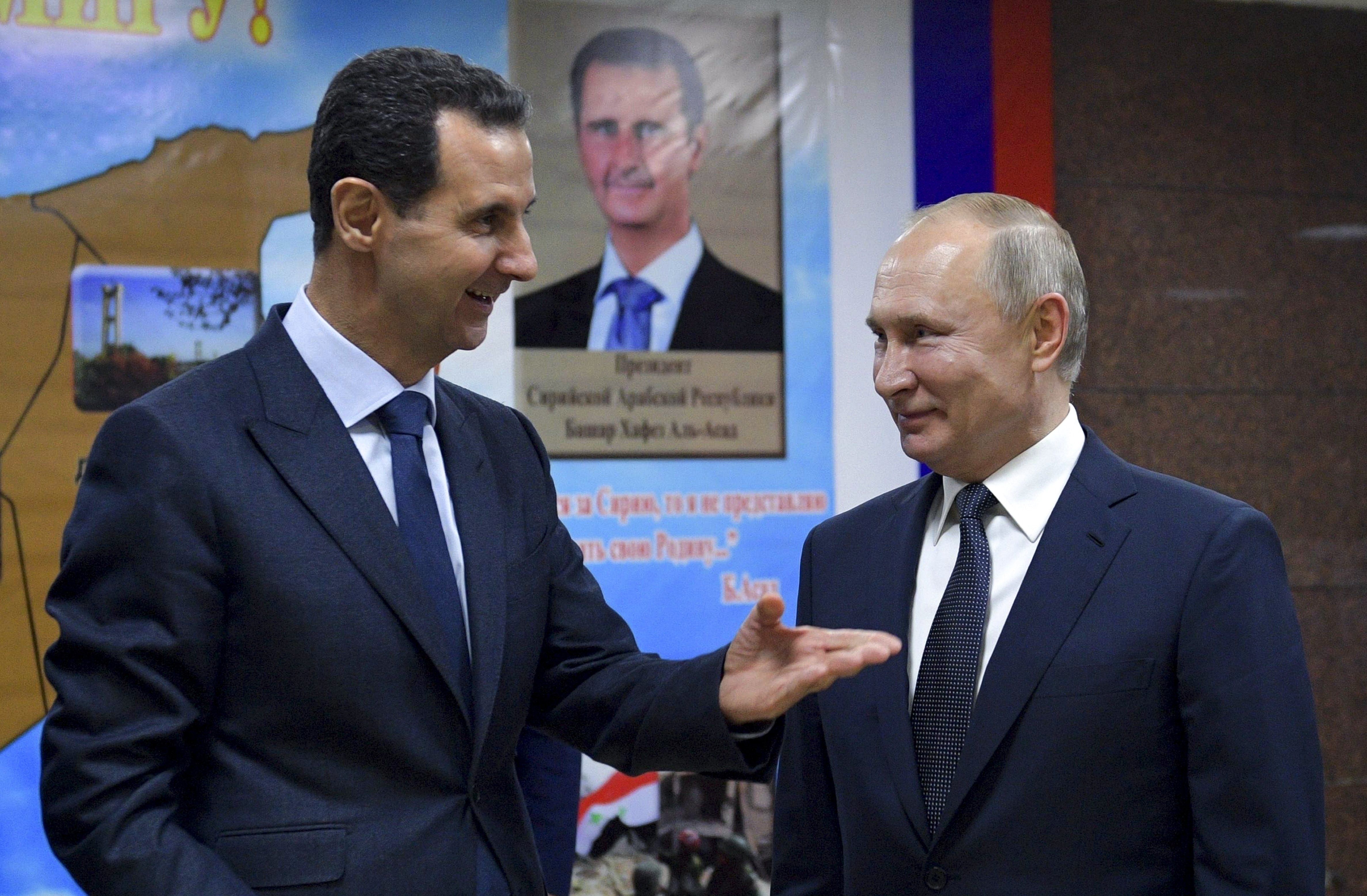 Former Syrian President Bashar Assad, left, speaks to Russian President Vladimir Putin in January 2020. (Alexei Druzhinin / Kremlin Pool via AP)