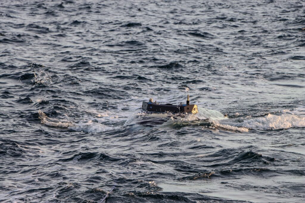  anti-submarine warfare  autonomous boats  Autonomous Underwater and Surface Vehicle (AUSV)  Kevin Decker  mine clearing  mine countermeasures  Navy  Ocean Aero  Operation Epic Fury  persian gulf  Sponsored Content  Strait of Hormuz  Triton  unmanned systems
