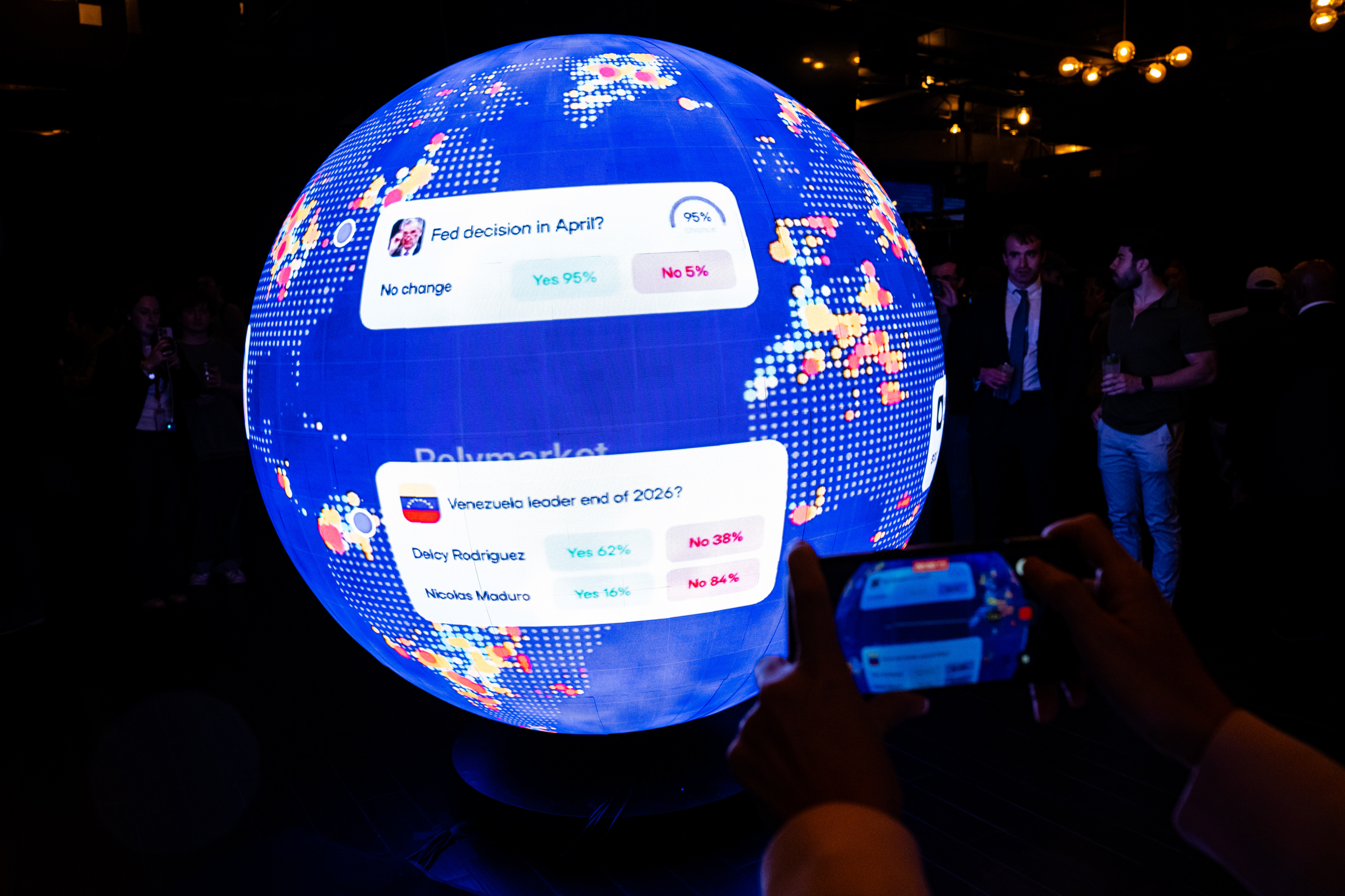 An electronic sphere displays Polymarket wagers during the opening of the company's pop-up bar in Washington, D.C., on March 20, 2026. (Graeme Sloan/Bloomberg via Getty Images)