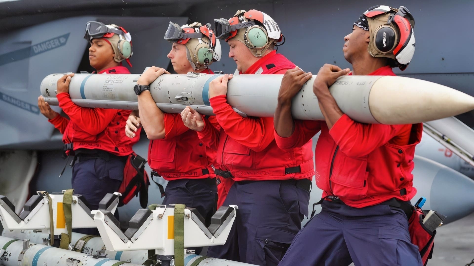 ATLANTIC OCEAN (July 31, 2018) Sailors prepare to transfer ordnance onto an F/A-18E Super Hornet from the Pukin' Dogs of Strike Fighter Squadron (VFA) 143 on the flight deck of the Nimitz-class aircraft carrier USS Abraham Lincoln (CVN 72). (U.S. Navy photo by Mass Communication Specialist 2nd Class Jessica Paulauskas/Released)