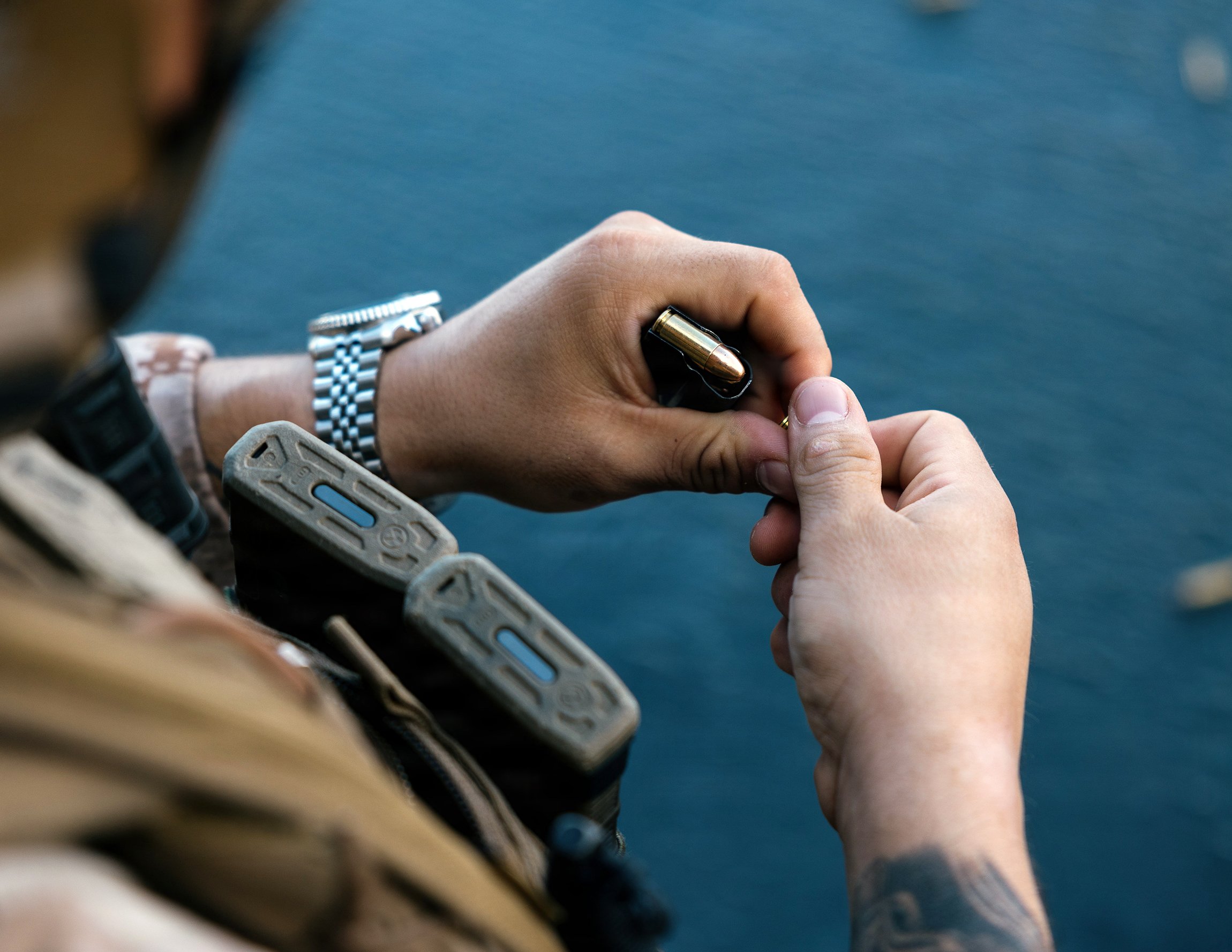 A U.S. Marine with the Maritime Raid Force, 11th Marine Expeditionary Unit, loads 9 mm ammunition during marksmanship training aboard Wasp-class amphibious assault ship USS Boxer (LHD 4) in the Pacific Ocean, April 25, 2026. The 11th MEU, embarked aboard the Boxer Amphibious Ready Group, is a persistent, combat credible force contributing to deterrence and crisis response in the U.S. 7th Fleet area of operations. U.S. 7th Fleet, the U.S. Navy's largest forward-deployed numbered fleet, routinely interacts and operates with allies and partners to preserve a free and open Indo-Pacific. (U.S. Marine Corps photo by Sgt. Joseph Helms)