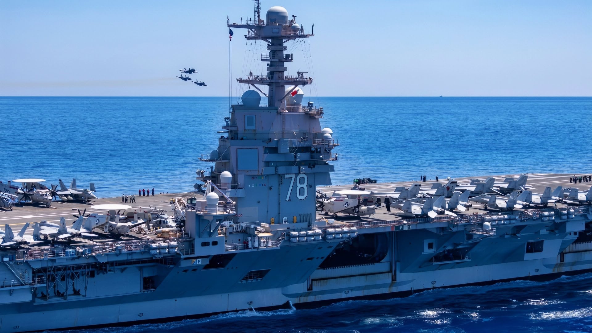 Carrier Air Wing 8 F/A-18E Super Hornets attached to Strike Fighter Squadron 37 fly by the world's largest aircraft carrier, USS Gerald R. Ford (CVN 78), during the squadron's in-flight change of command ceremony, August 1, 2025. Gerald R. Ford, a first-in-class nuclear aircraft carrier and deployed flagship of Carrier Strike Group Twelve, is on a scheduled deployment in the U.S. 6th Fleet area of operations to support the warfighting effectiveness, lethality, and readiness of U.S. Naval Forces Europe-Africa, and defend U.S., Allied, and partner interests in the region. (U.S. Navy photo by Mass Communication Specialist Seaman Brianna Barnett)
