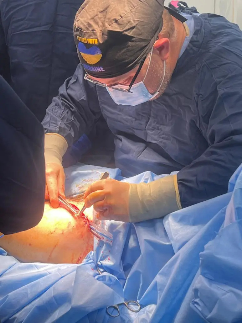 Dr. Michael Samotowka performs surgery in Ukraine. The volunteer trauma surgeon and surgical critical care specialist regularly trains Ukrainian surgeons in managing complex war-related trauma with the nonprofit group MedGlobal, which provides emergency care to communities in crisis. (Photo courtesy of Michael Samotowka)