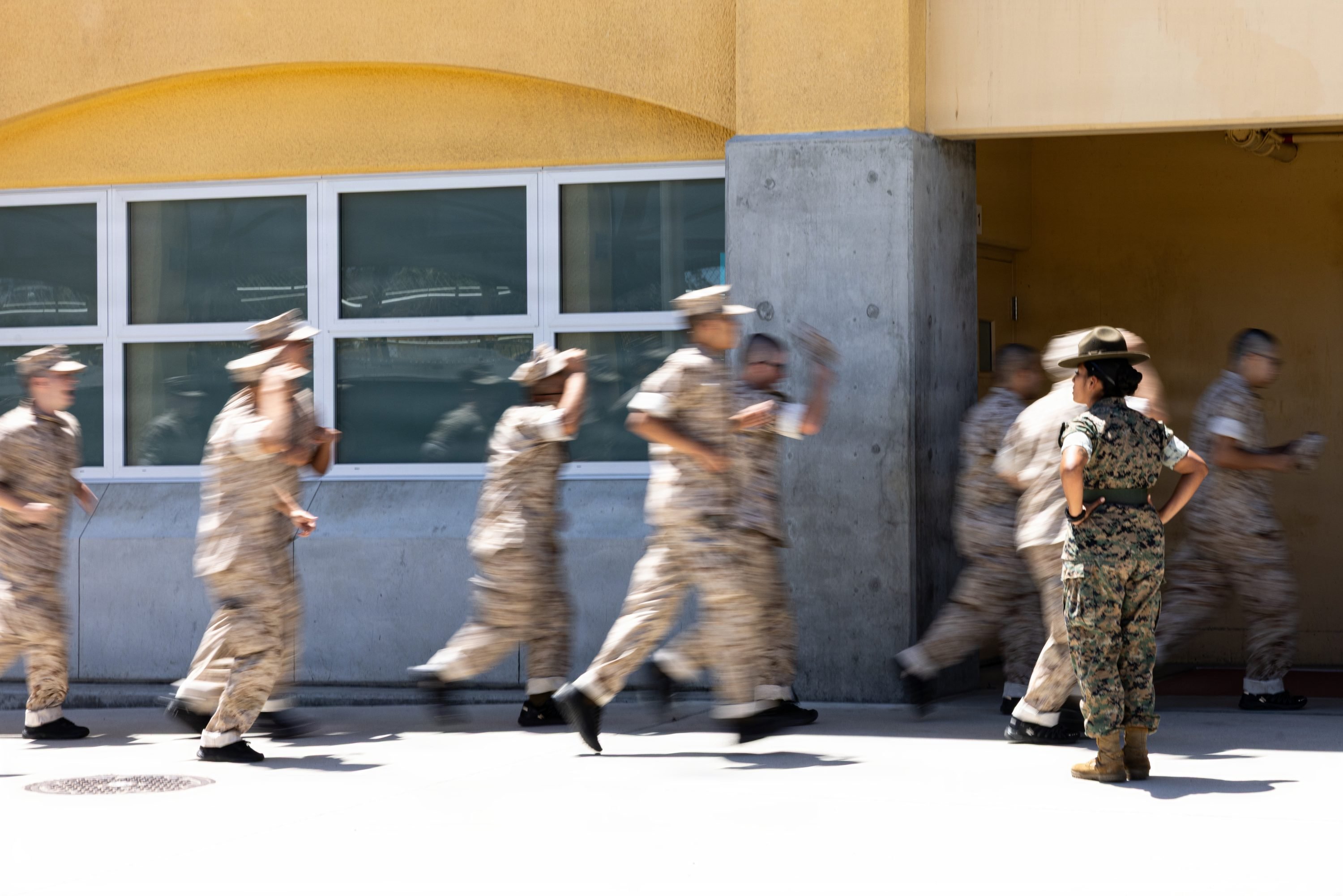 U.S. Marine Corps recruits with Mike Company, 3rd Recruit Training Battalion run to their squad-bay during Pick-Up Day at Marine Corps Recruit Depot San Diego, California, May 30, 2026. Pick-Up Day signifies the first official day of training in which recruits will meet their drill instructor team for the first time, prepare their gear and squad bays, and expectations are set for the remainder of their time in recruit training. (U.S. Marine Corps photo by Cpl. Evelyn Doherty)