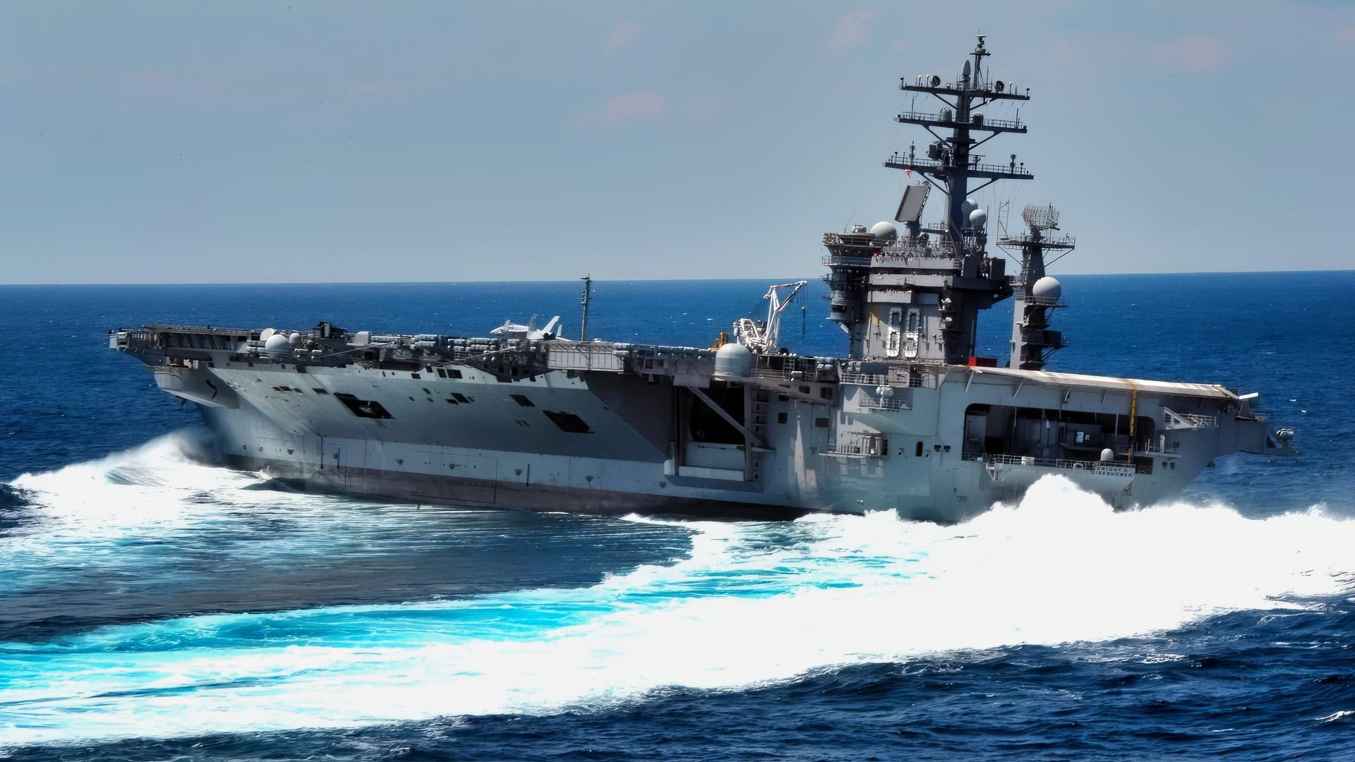 The Nimitz-class aircraft carrier USS Dwight D. Eisenhower conducts rudder turns during sea trials. Dwight D. Eisenhower completed a nine-month planned incremental availability at Norfolk Naval Ship Yard on June 10 and is scheduled to resume underway operations this summer.