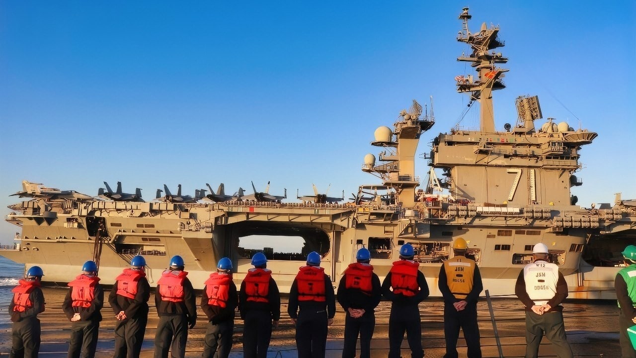 PACIFIC OCEAN (Nov. 28, 2023) Line handling crew assigned to the Arleigh Burke-class guided-missile destroyer USS John S. McCain (DDG 56) prepares to come alongside USS Theodore Roosevelt (CVN 71) for a replenishment at sea. John S. McCain is currently conducting routine training and certifications in the U.S. 3rd Fleet area of operations. (U.S. Navy photo by Ensign Garrett Fox).