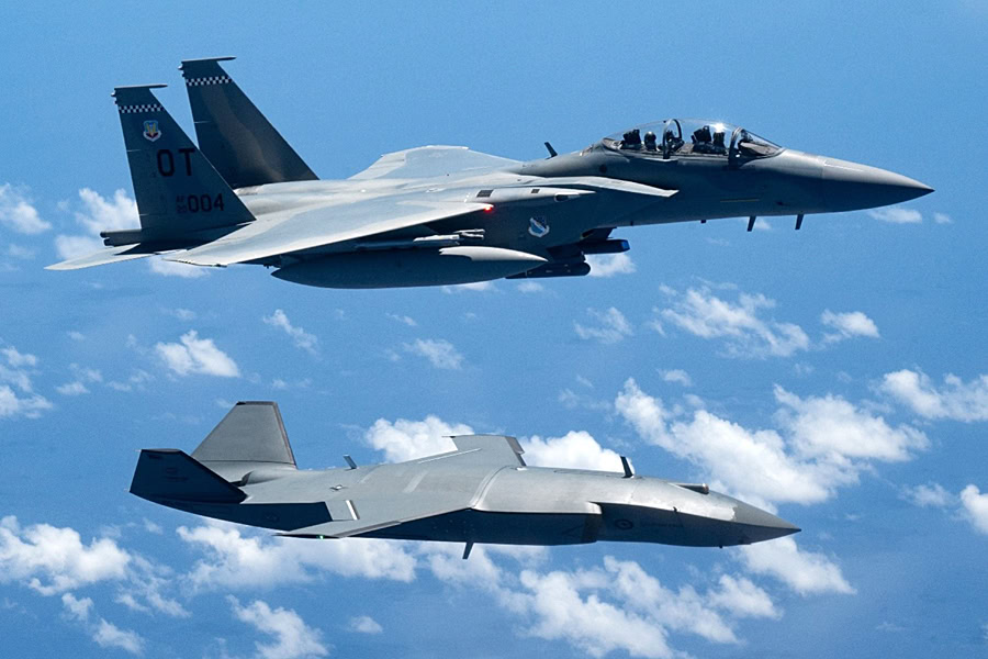 An MQ-28 Ghost Bat and US Air Force F-15EX Eagle II pictured together during Exercise VALIANT SHIELD 2026 over the Philippine Sea. US Pacific Air Forces photo