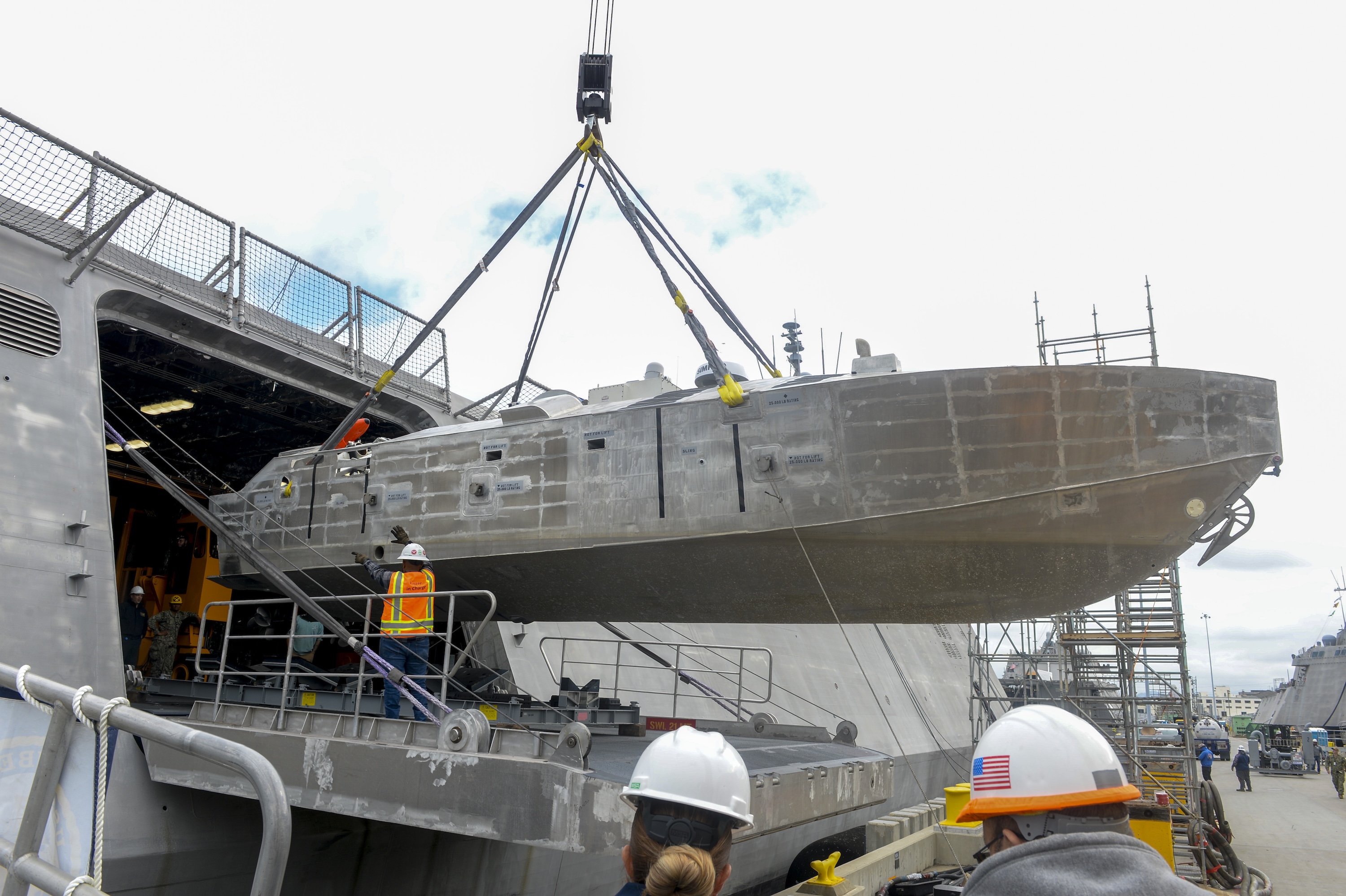 An unmanned surface vehicle is craned aboard the USS Canberra as a part of the first embarkation of the MCM mission package, April 23, 2024. (MC1 Vance Hand/U.S. Navy)