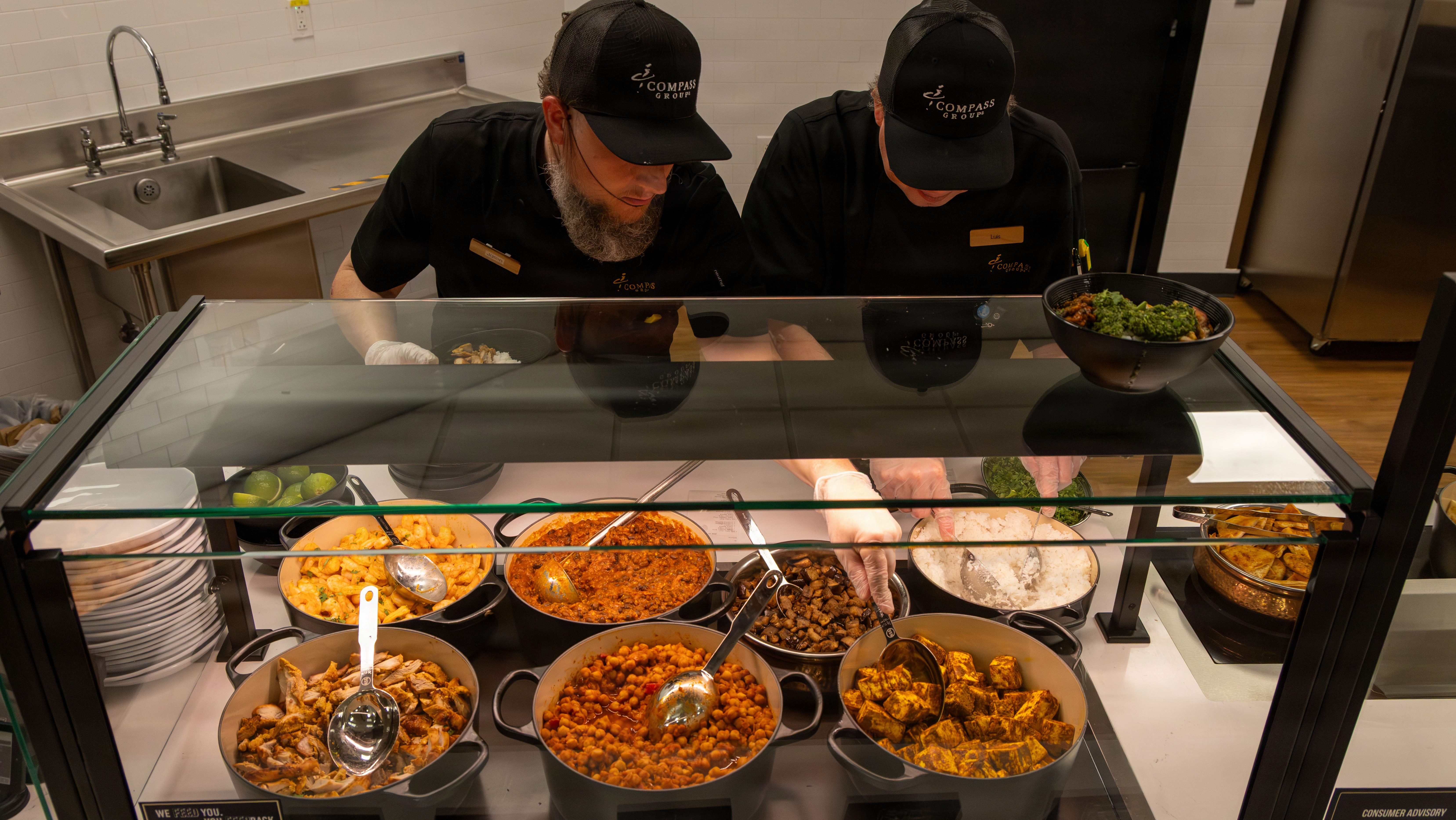 Rally Point Bistro food service employees prepare meals during the dining venue grand opening at Fort Bragg, N.C., Sept. 29, 2026. The dining venue offers a variety of nutritious, performance-focused meal options designed to fuel Soldiers for the demands of training and daily operations. (U.S. Army photo by Staff Sgt. Nirak Garcia Navarro)