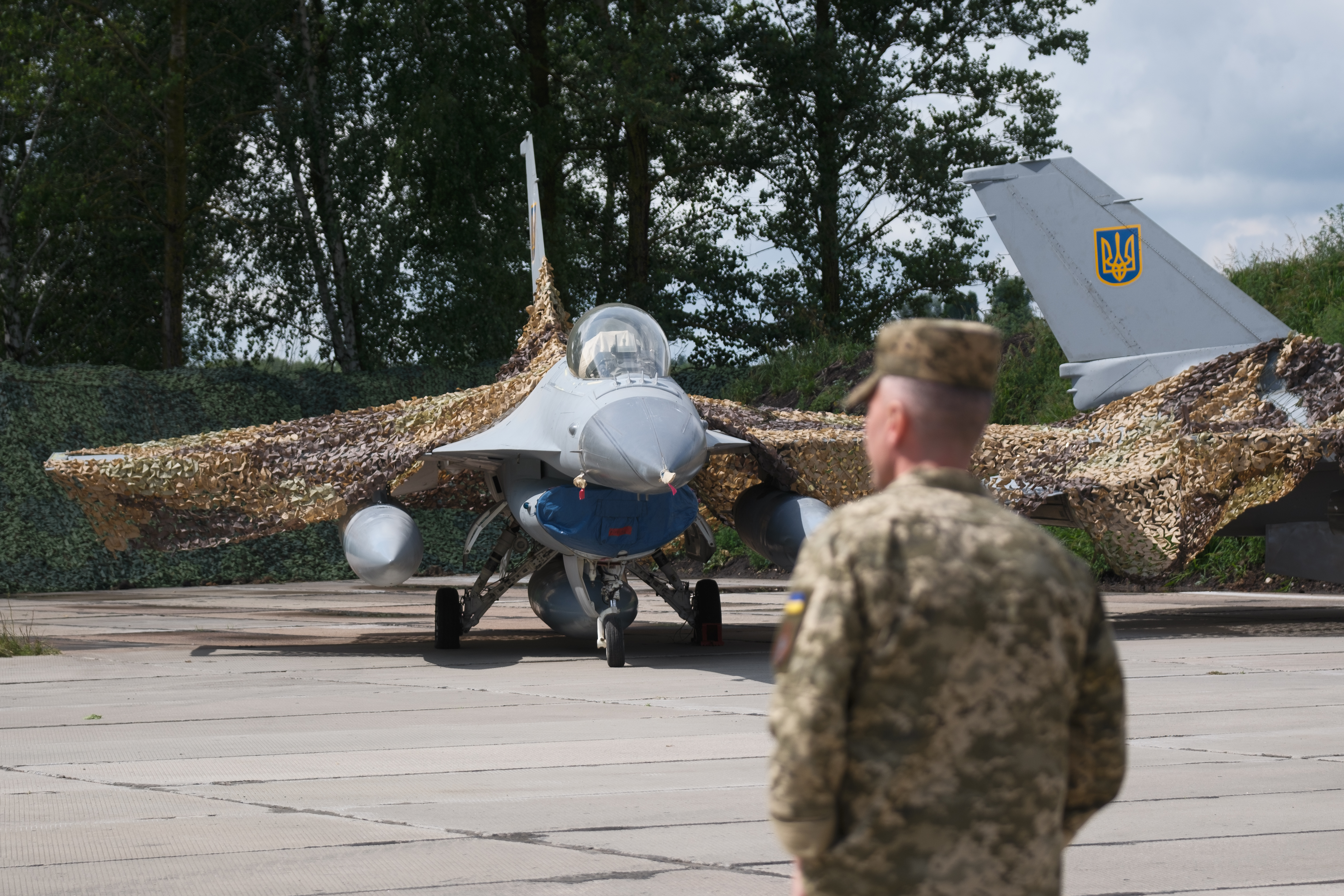 A Ukrainian military member stands next to one of the first General Dynamics F-16s received by Ukraine on August 4, 2024. (Vitalii Nosach/Global Images Ukraine via Getty Images)