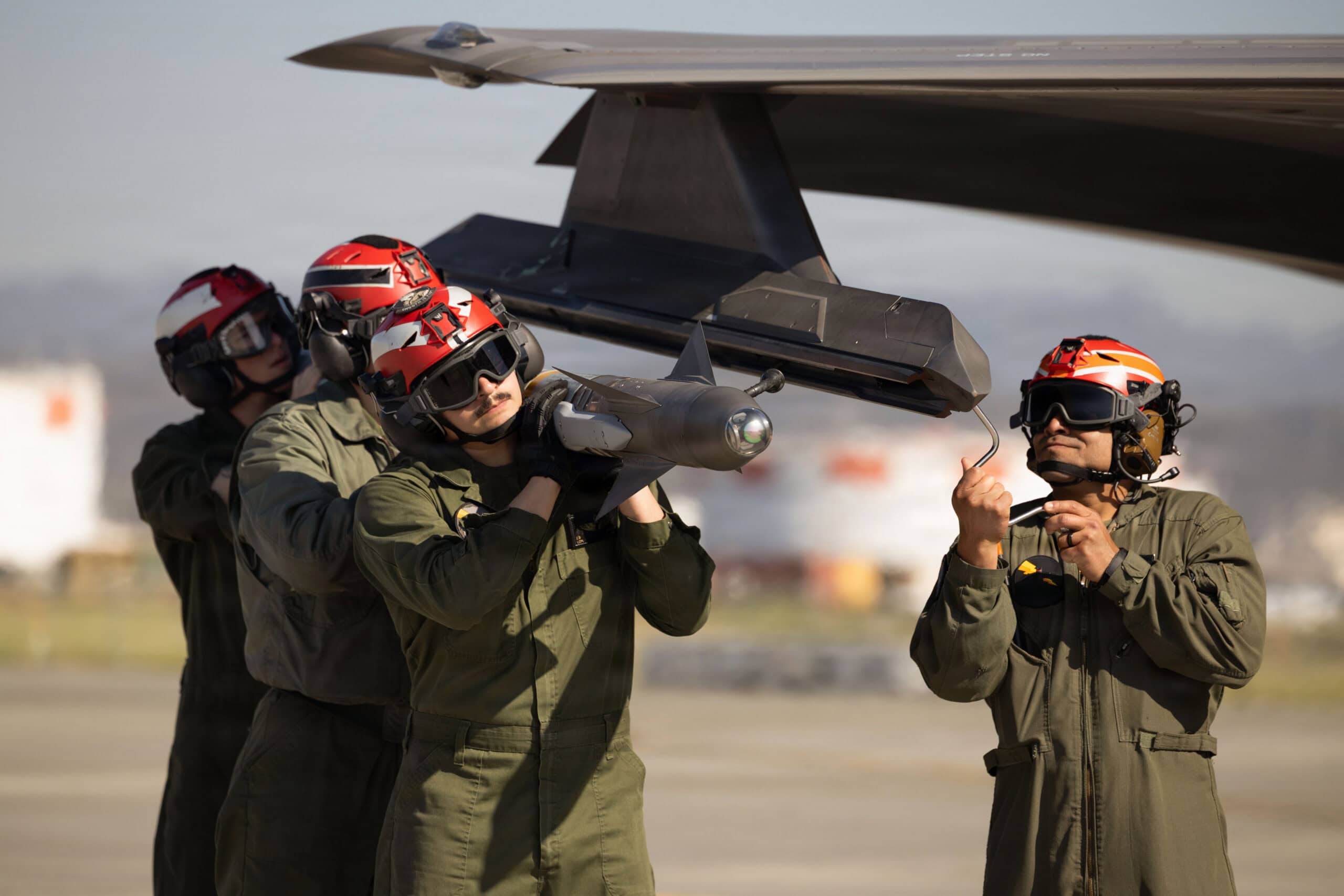 U.S. Marines with Marine Fighter Attack Squadron (VMFA) 242, Marine Aircraft Group 12, 1st Marine Aircraft Wing, load an AIM-9X Sidewinder missile onto an F-35B Lightning II aircraft at Marine Corps Air Station Iwakuni, Yamaguchi, Japan, April 8, 2026. VMFA-242 and Marine Aviation Logistics Squadron 12 maintain operational readiness through routine flight operations and ordnance loading. (U.S. Marine Corps photo by Cpl. Cecilia Campbell)