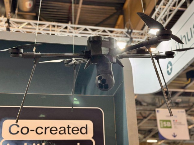 3D-printed plastic prototype of a payload mounted on a real-size drone, Eurosatory 2026 ][Source: Tactical Photonics]