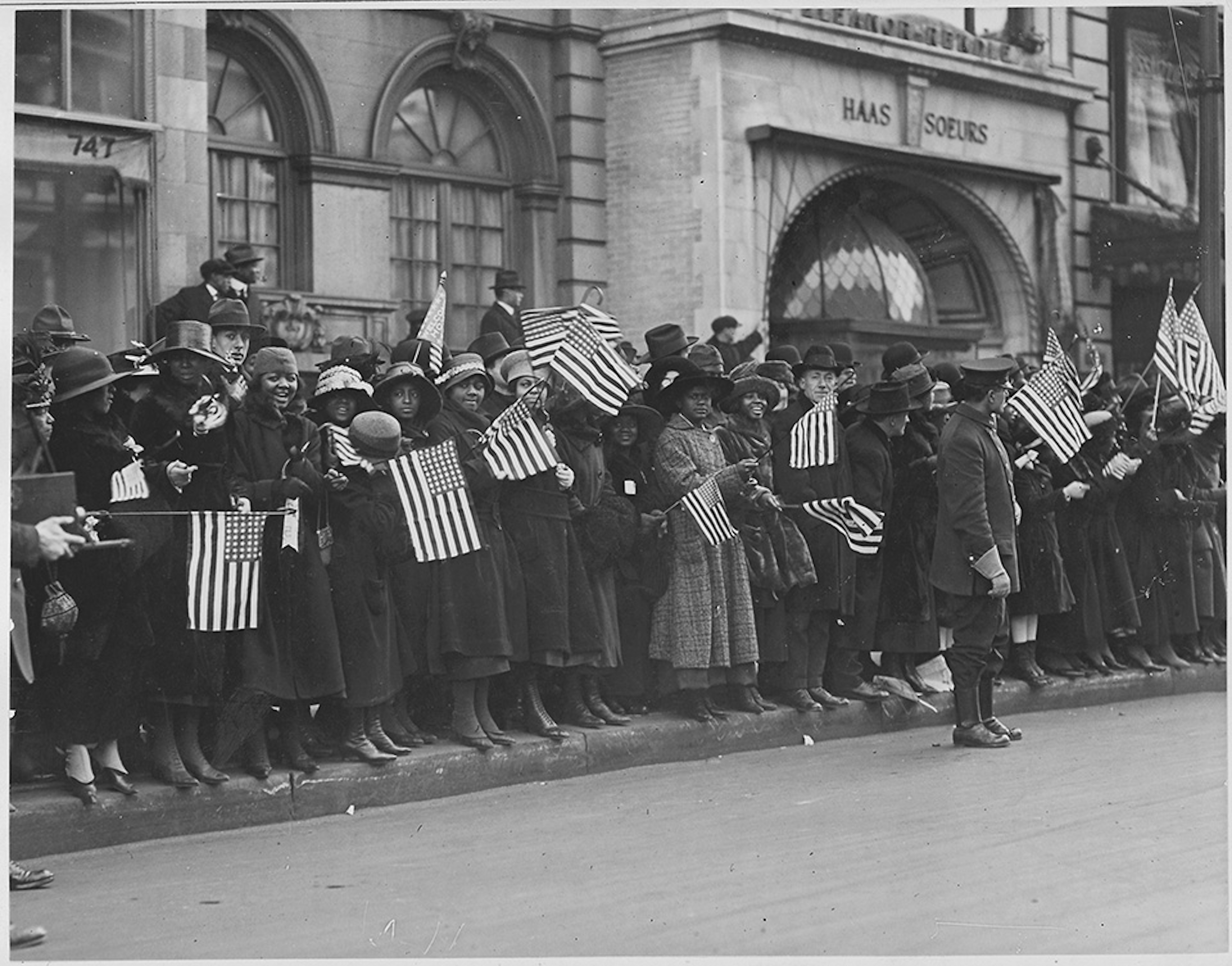 Throngs of New Yorkers line Fifth Avenue to welcome home the soldiers of the 369th Infantry Regiment returning from World War I. But despite their valiant, patriotic service, members of the Black unit continued to face racism and discrimination at home. (National Archives)
